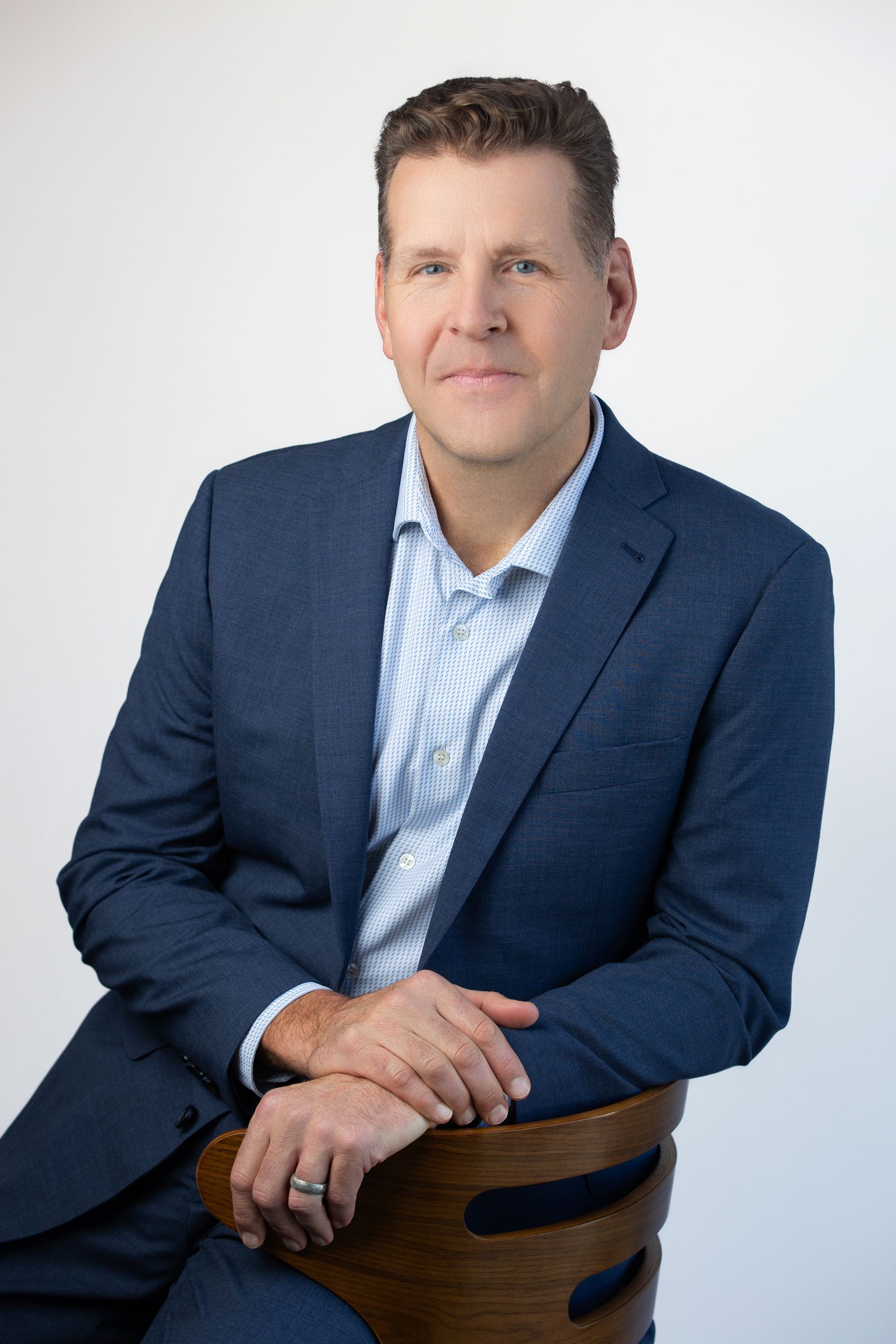 Photo Pete Behrens wearing a navy blue suit
