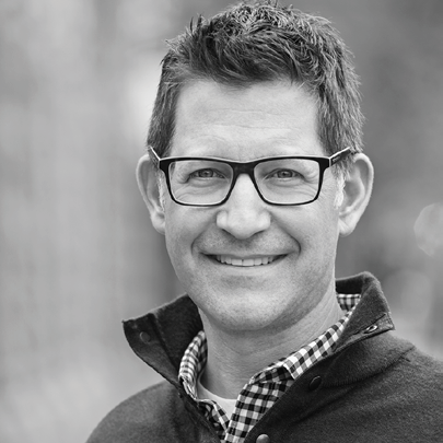 Black and white headshot of Sal Silvester, a white man with short dark hair and glasses