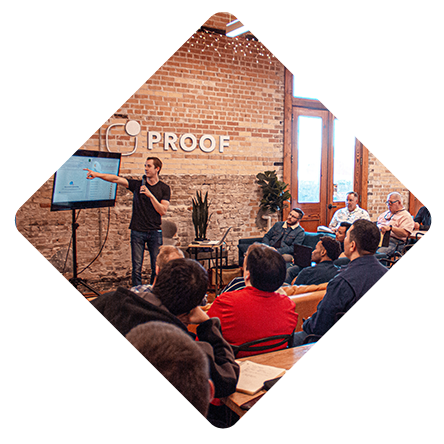 A man is giving a presentation to a group of people in a room.