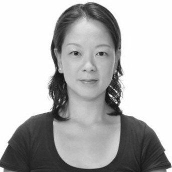 A black and white photo of a woman wearing a black shirt.