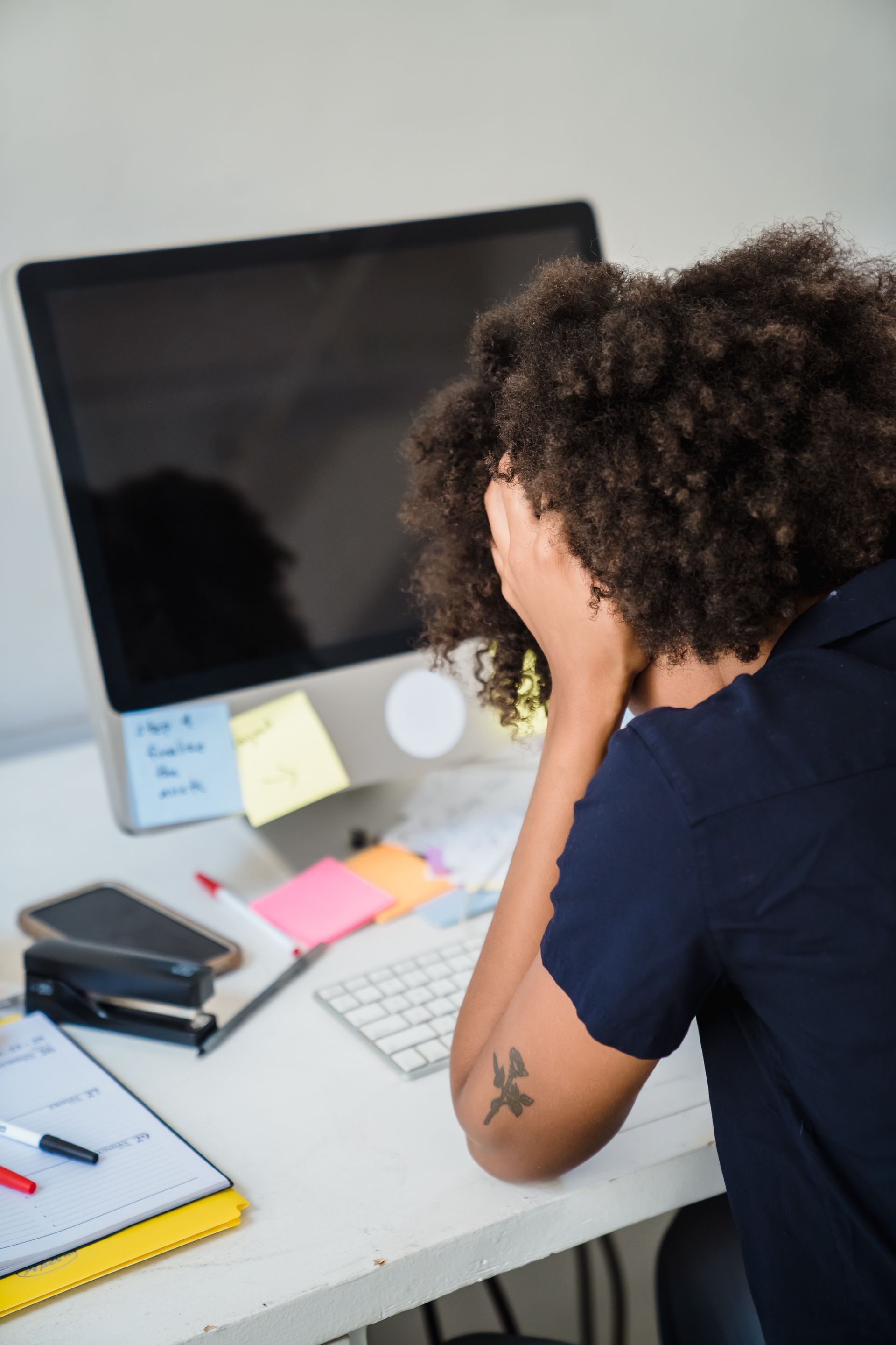 Frustrated woman sitting at an office desk