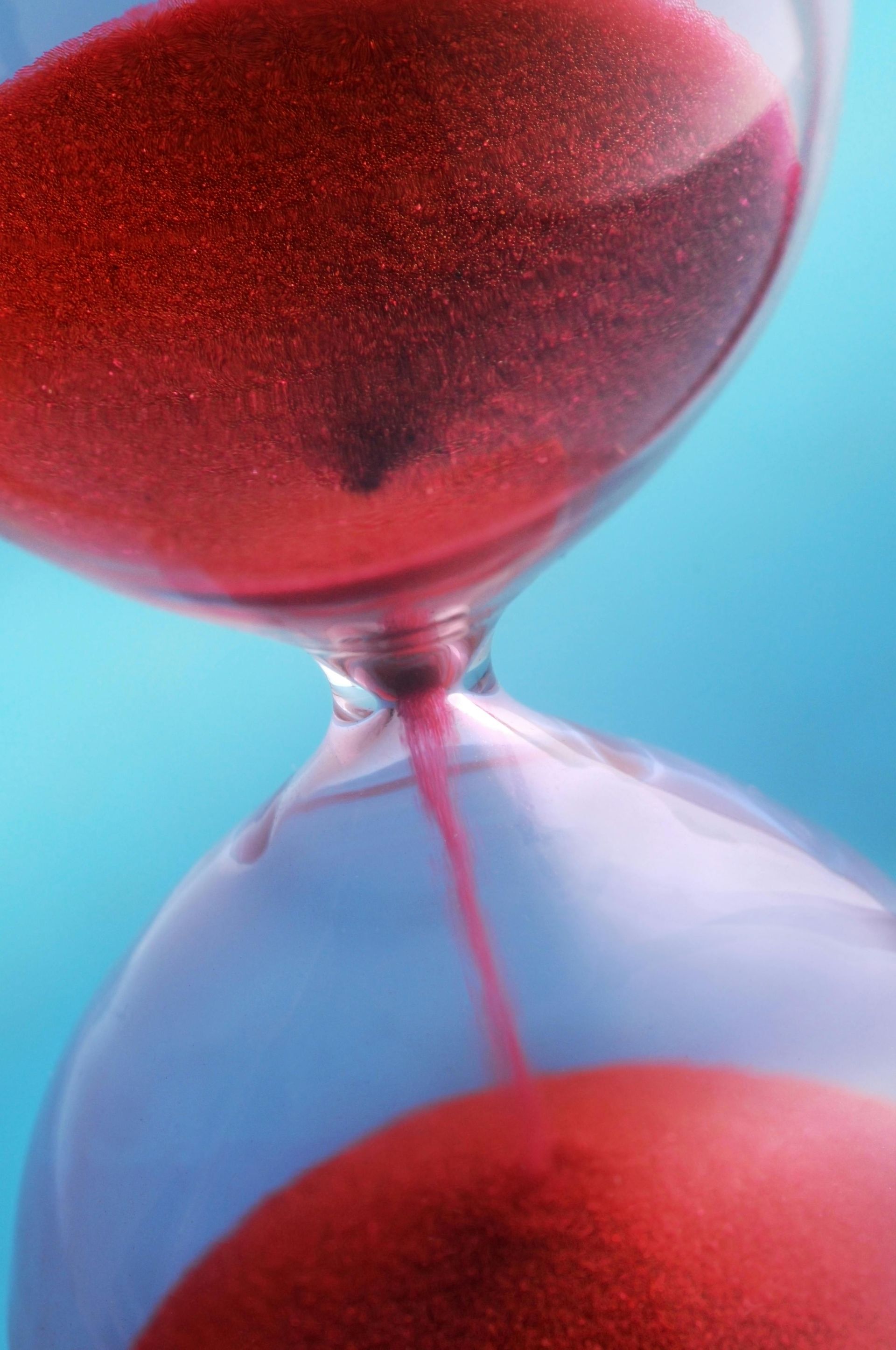 Hourglass with red sand representing procurement and sourcing bottlenecks