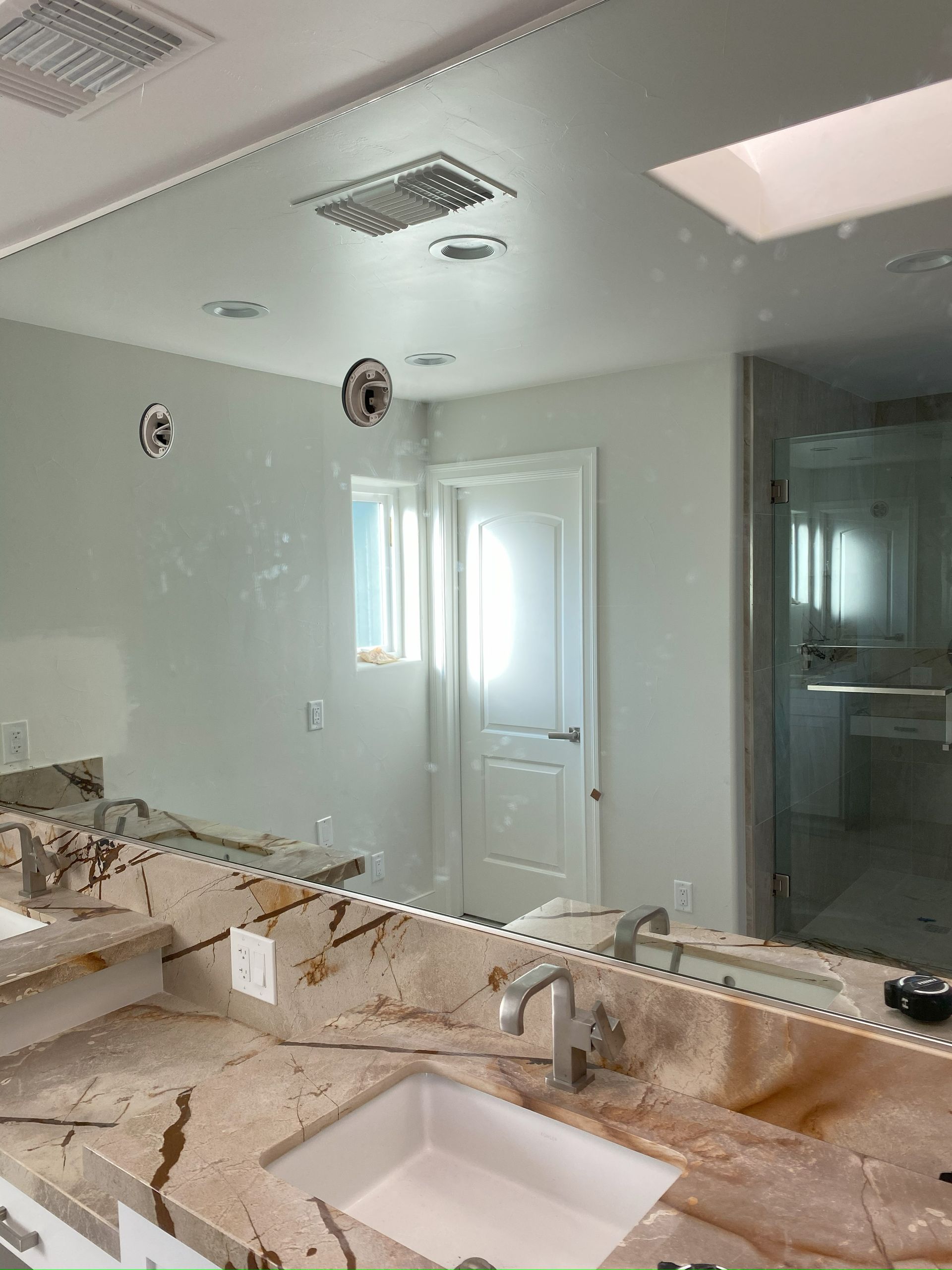 Custom cut mirror mounted on wall