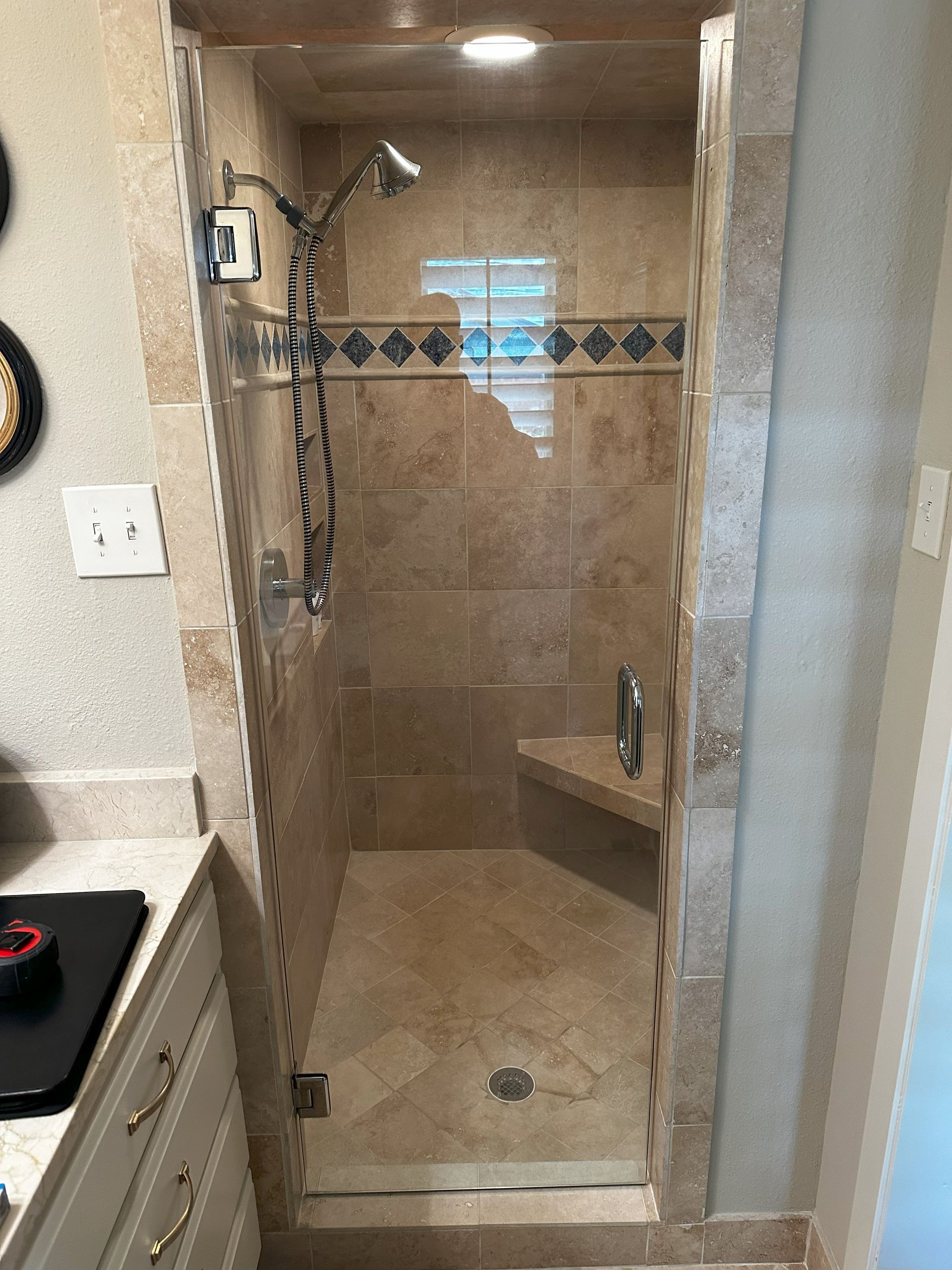 Frameless glass shower enclosure installed in San Antonio bathroom