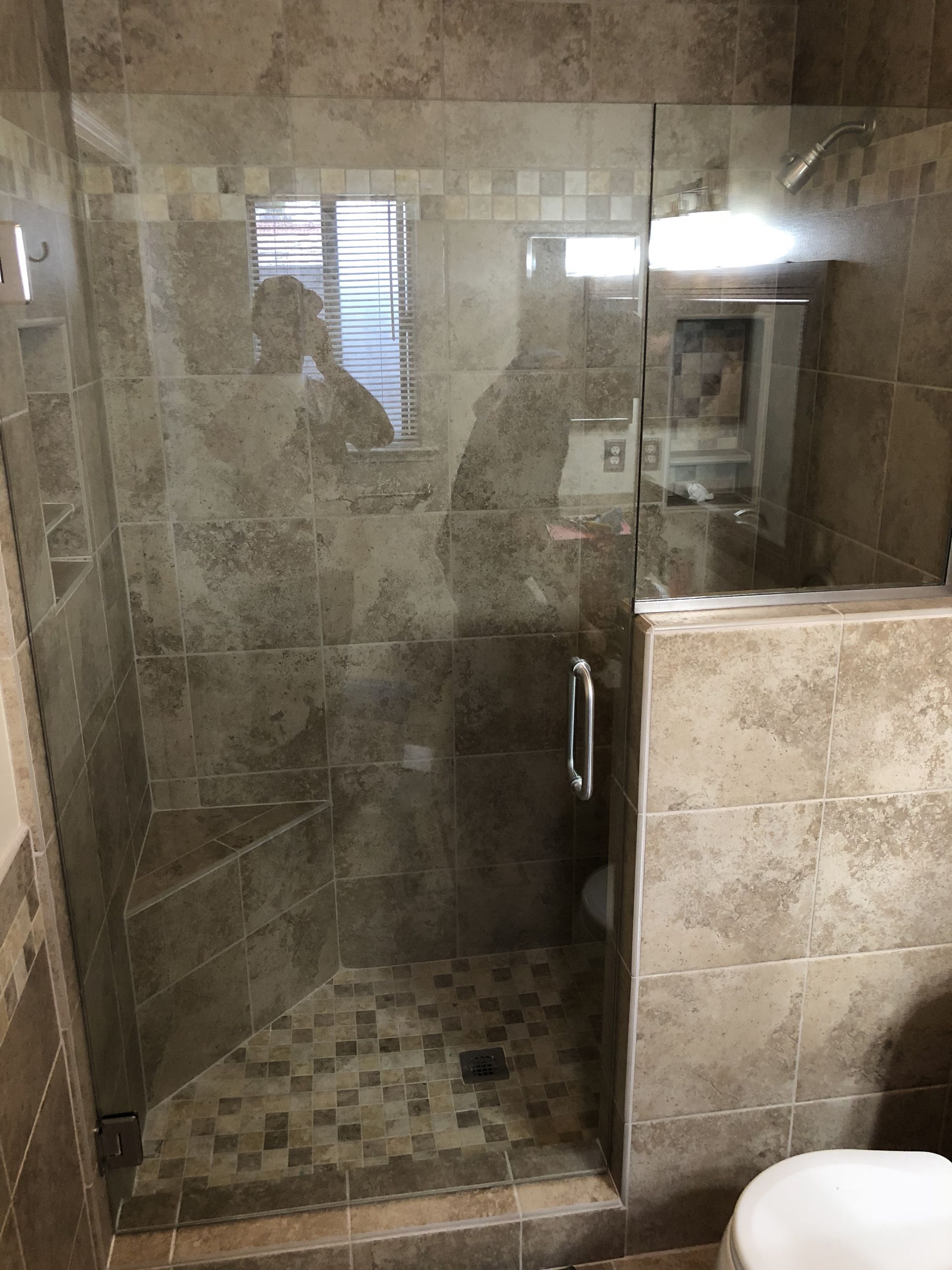 Frameless glass shower enclosure installed in San Antonio bathroom