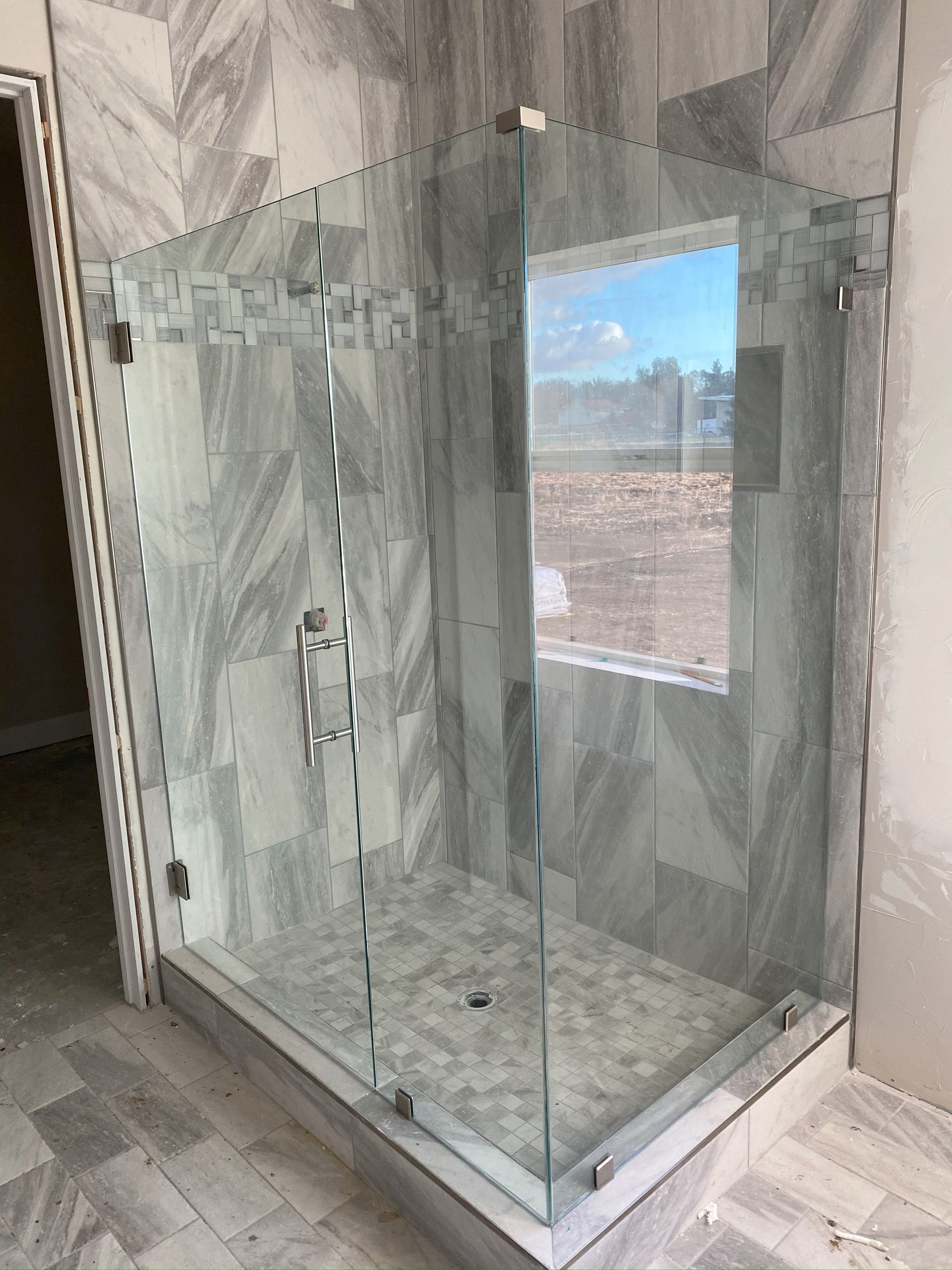 Frameless glass shower enclosure installed in San Antonio bathroom