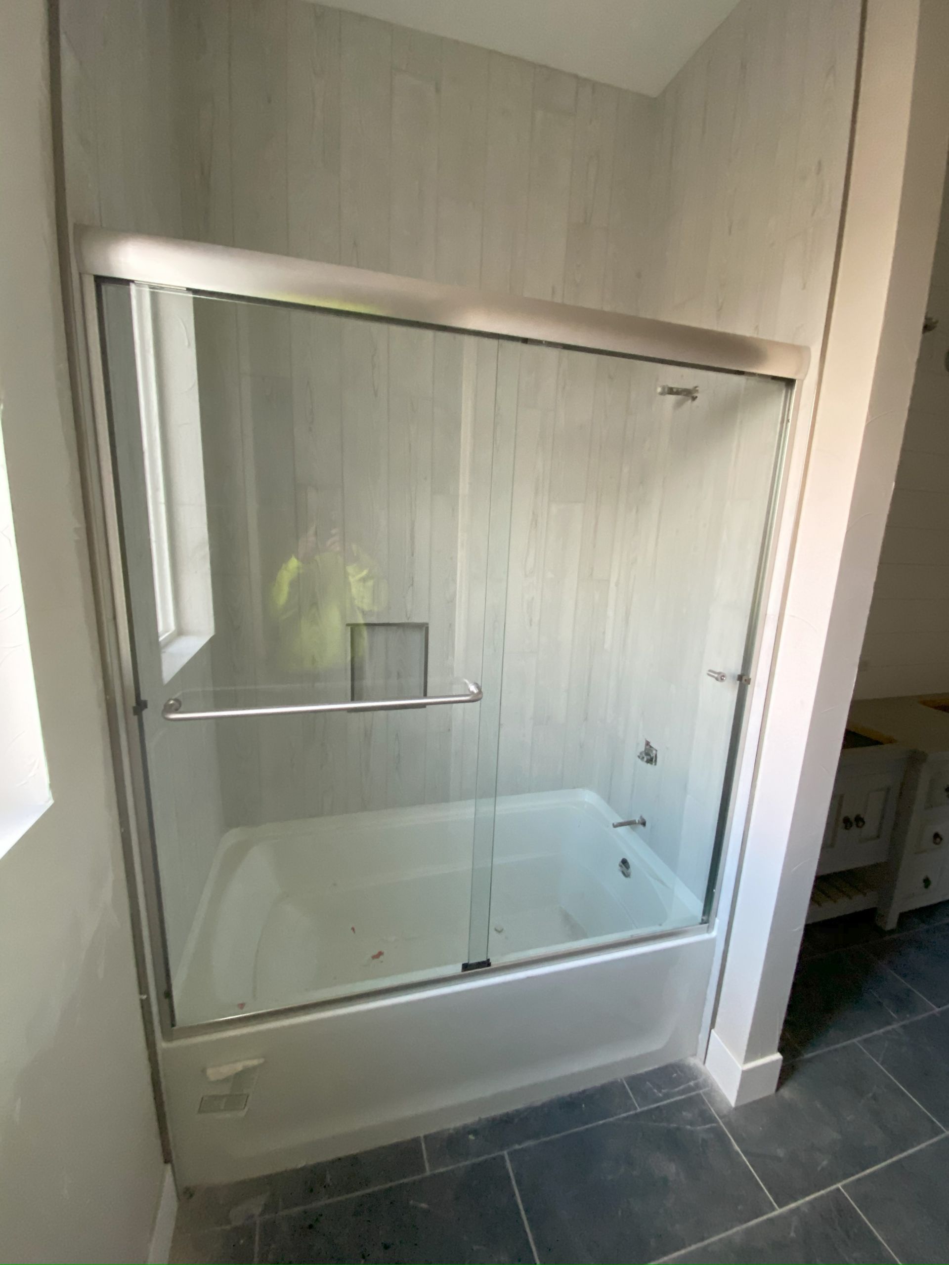 Frameless glass shower enclosure installed in San Antonio bathroom