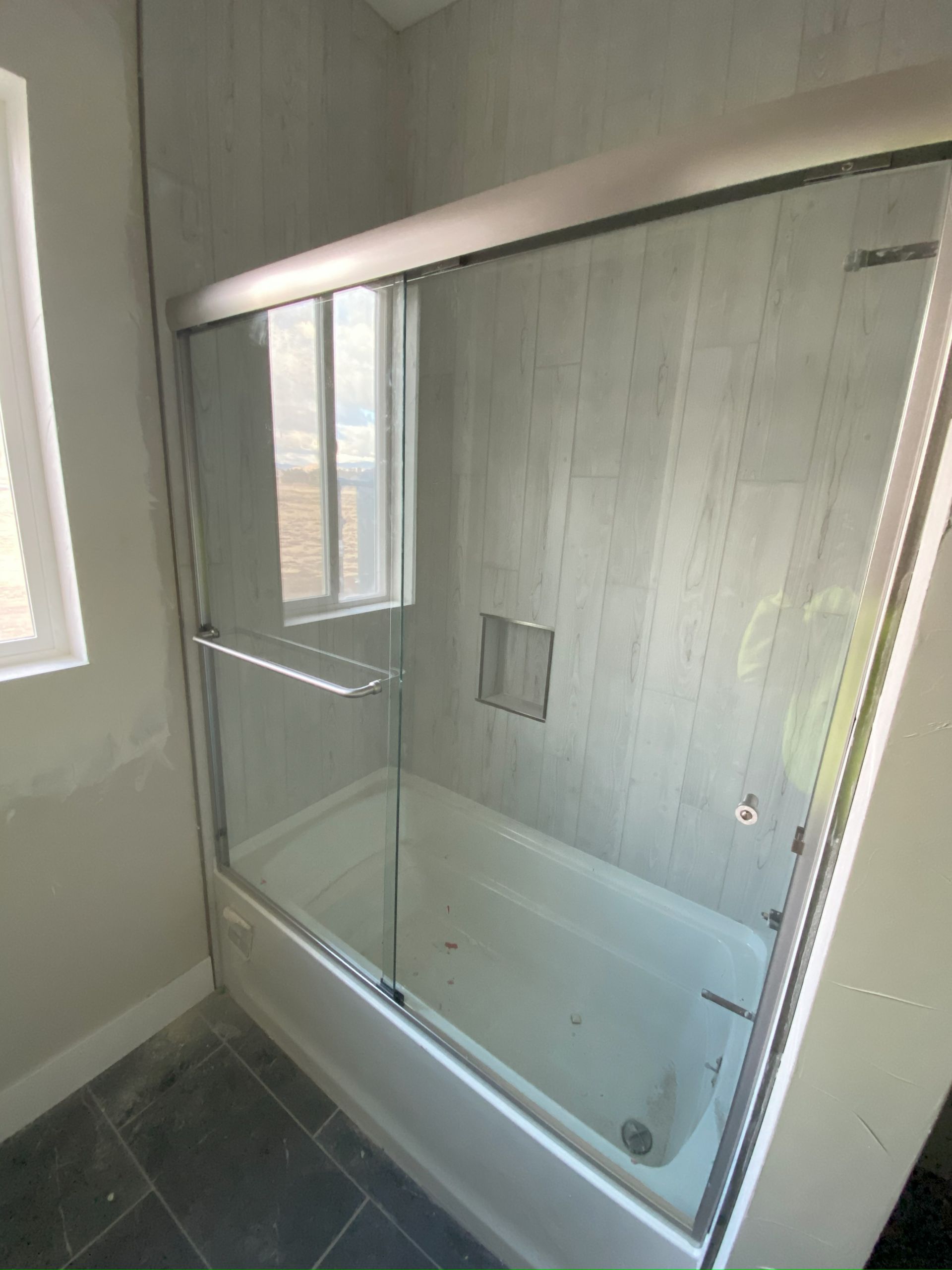 Frameless glass shower enclosure installed in San Antonio bathroom