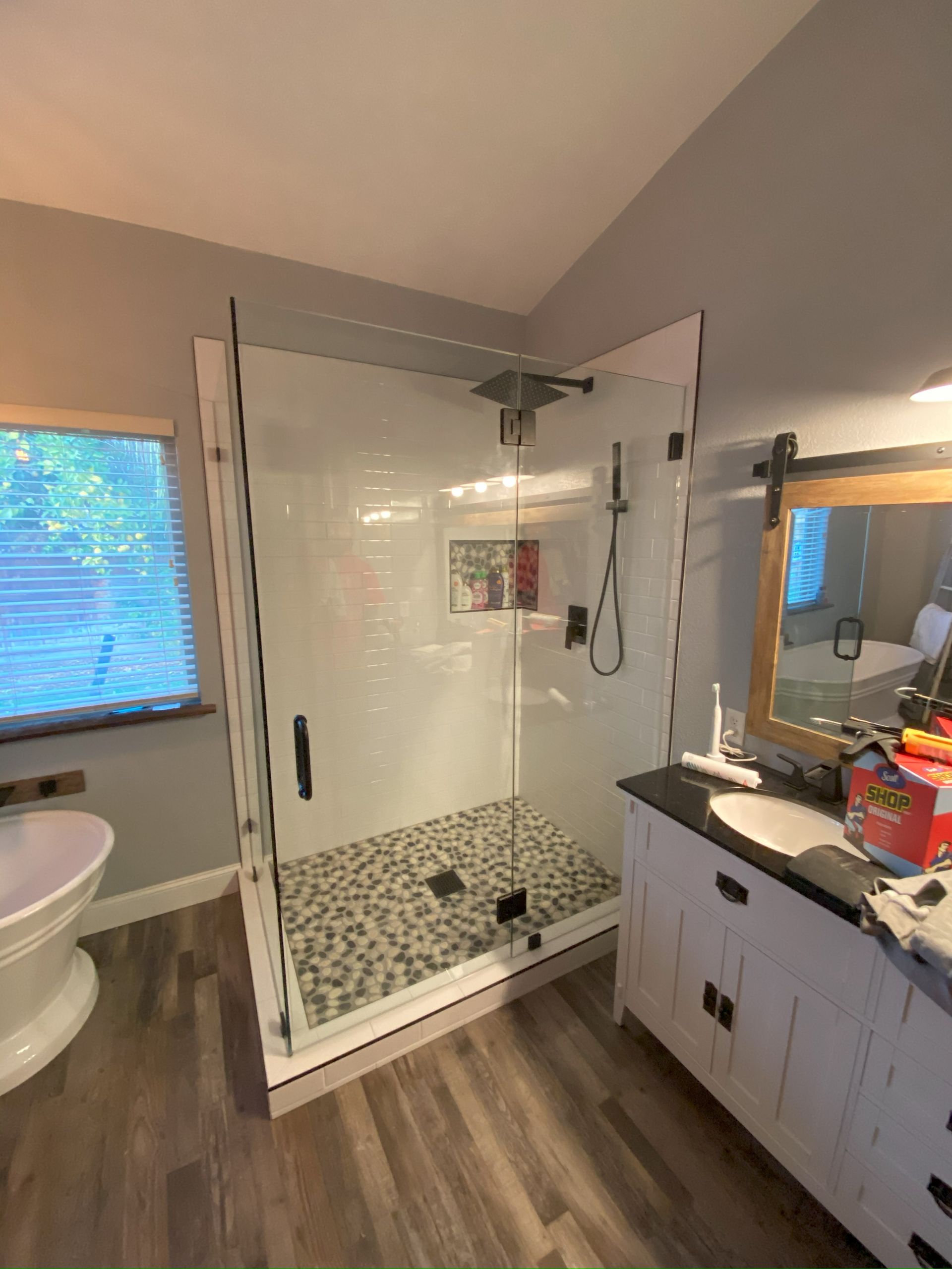 Precision glass shower enclosure by Glassology with tight seams and polished hardware