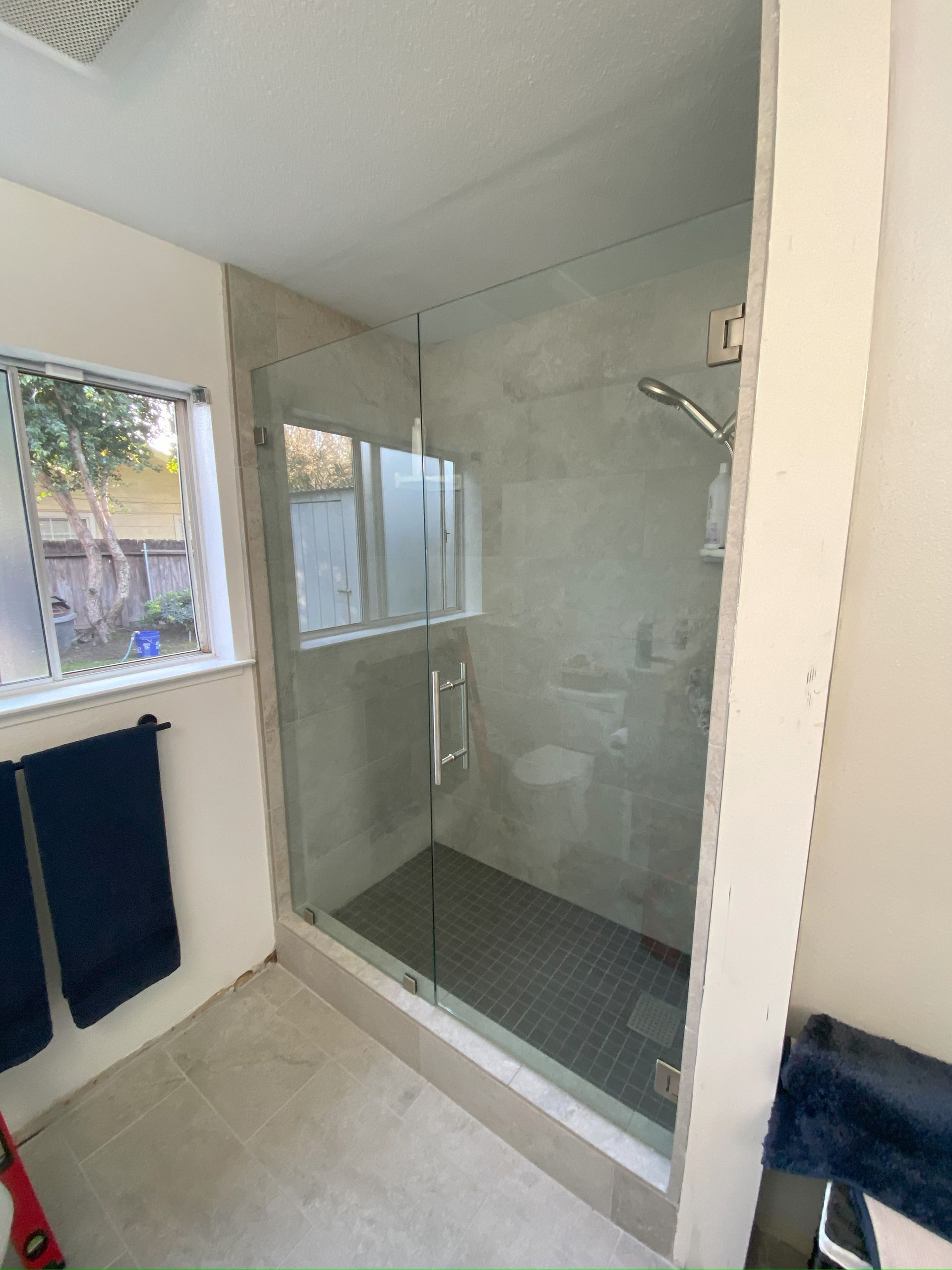 Frameless glass shower enclosure installed in San Antonio bathroom