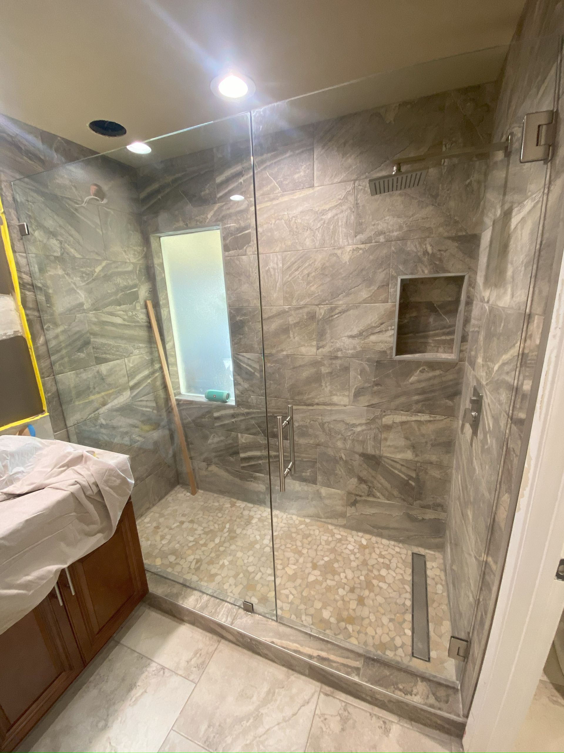 Frameless glass shower enclosure installed in San Antonio bathroom