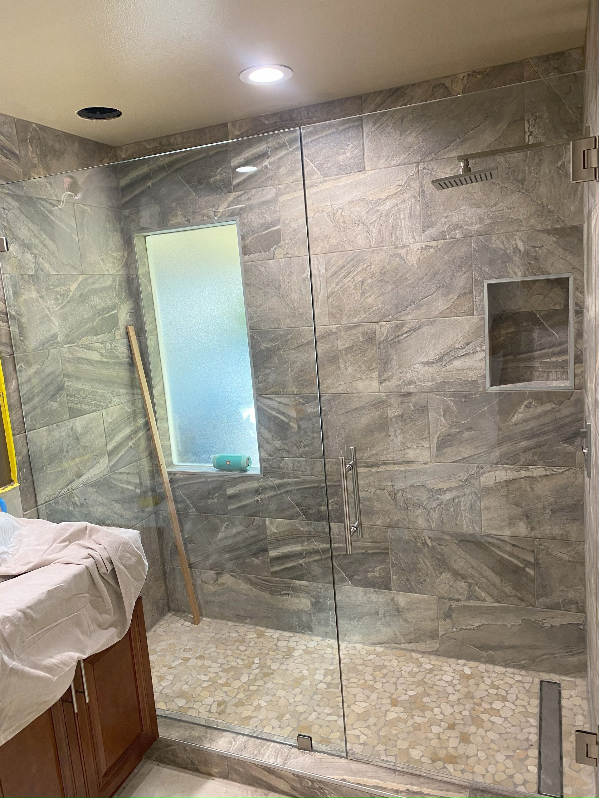 Frameless glass shower enclosure installed in San Antonio bathroom