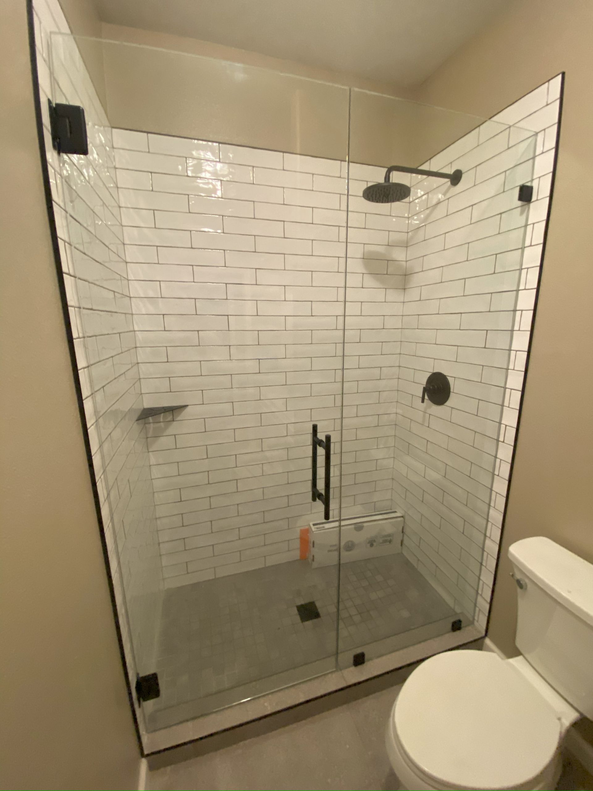 Frameless glass shower enclosure installed in San Antonio bathroom