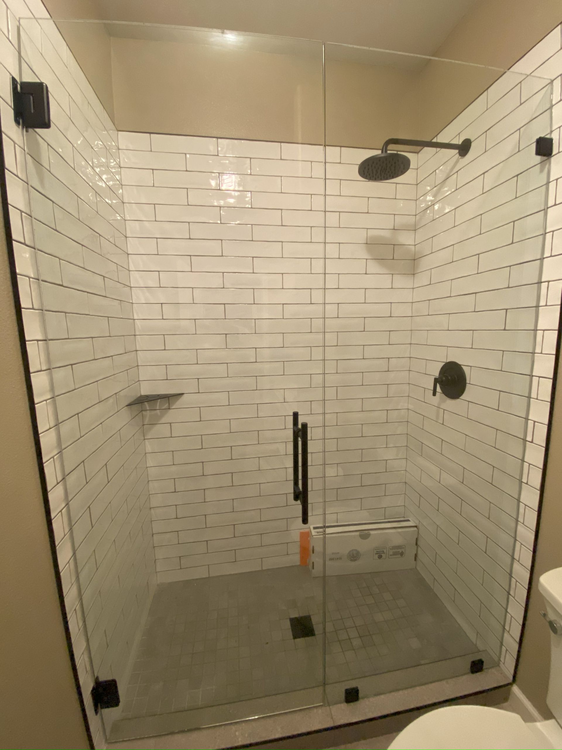 Frameless glass shower enclosure installed in San Antonio bathroom
