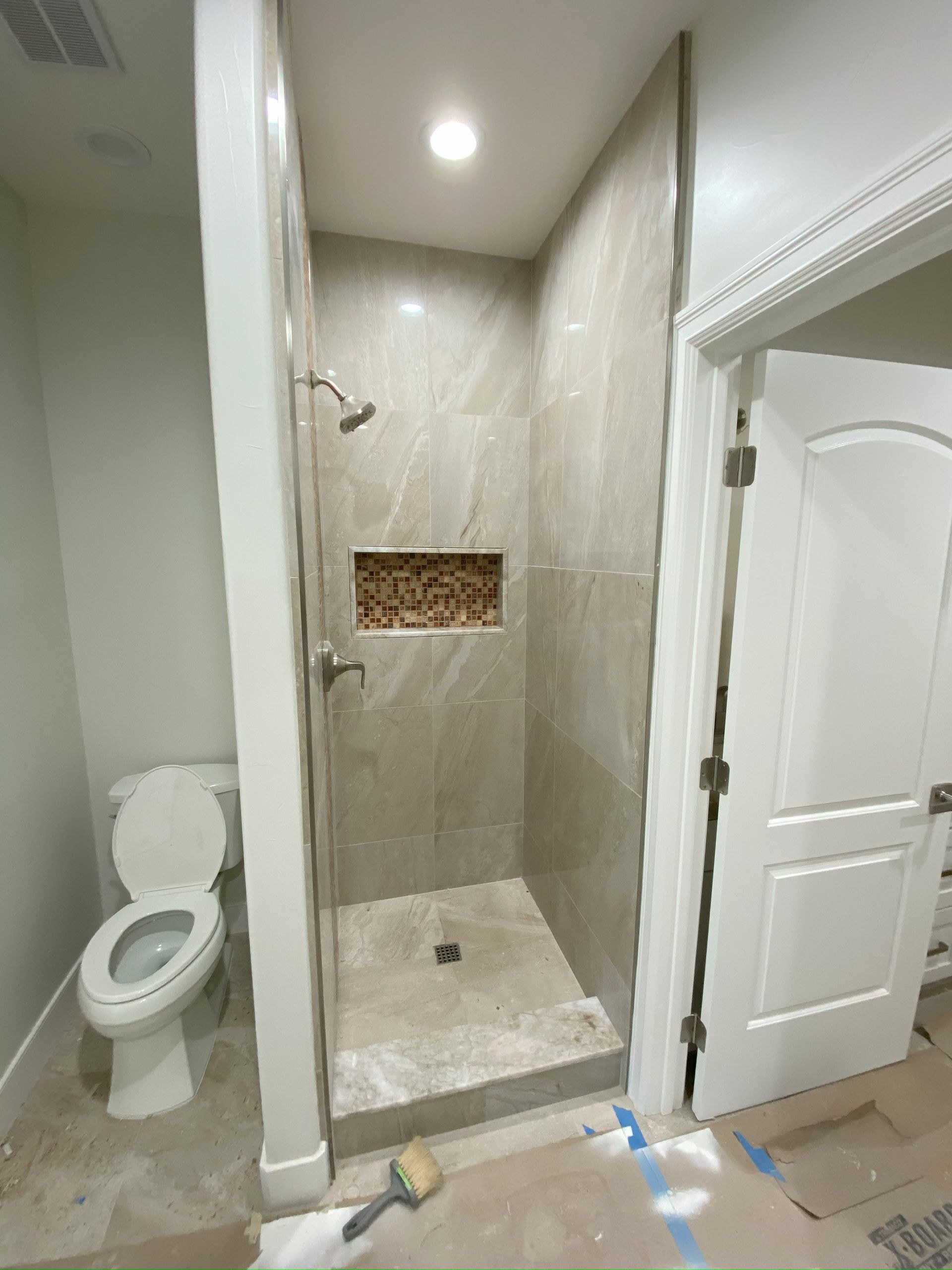 Modern bathroom with clear frameless glass shower panels