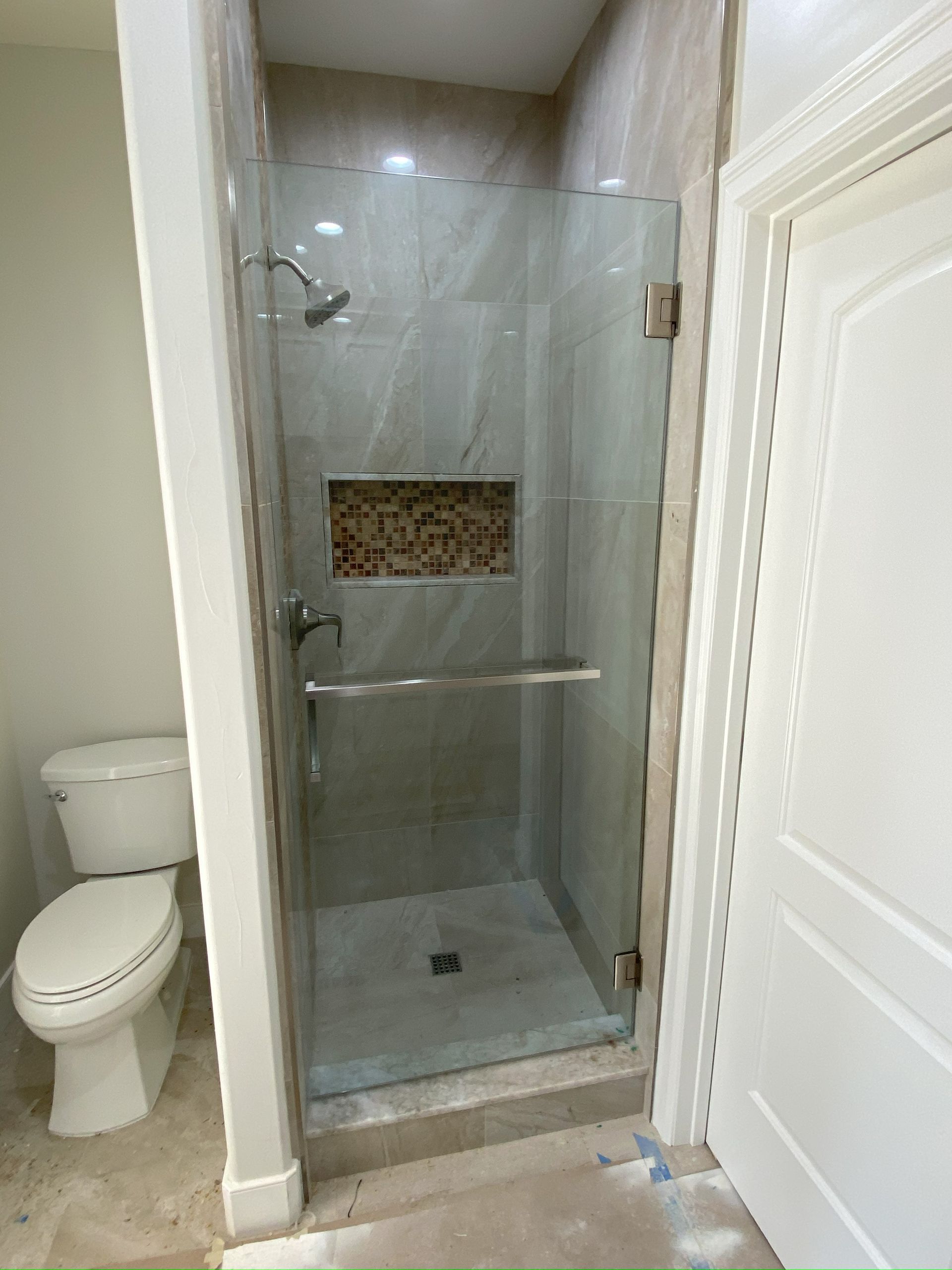High-end bathroom remodel featuring frameless shower glass