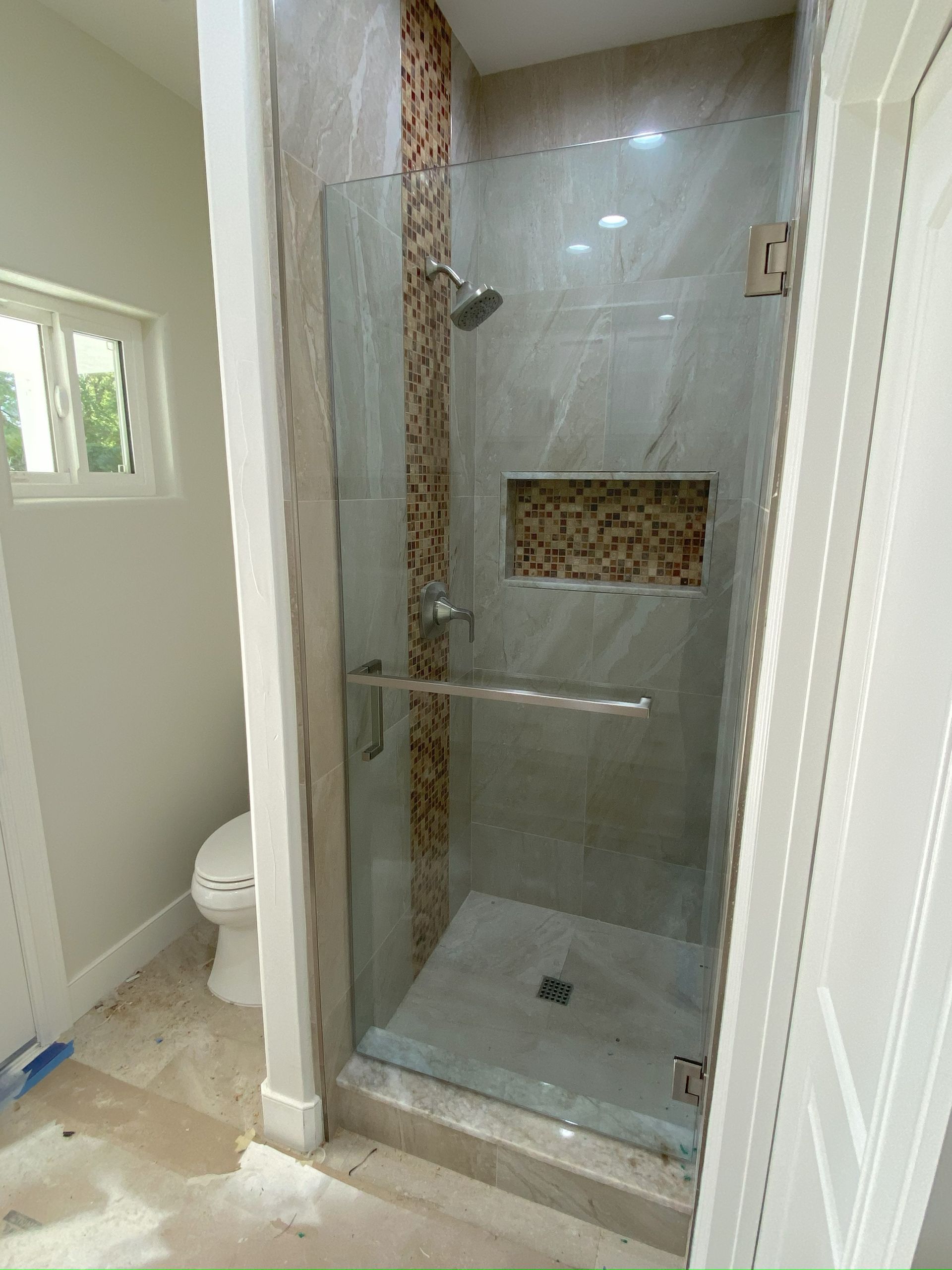 Contemporary shower design with custom glass panels