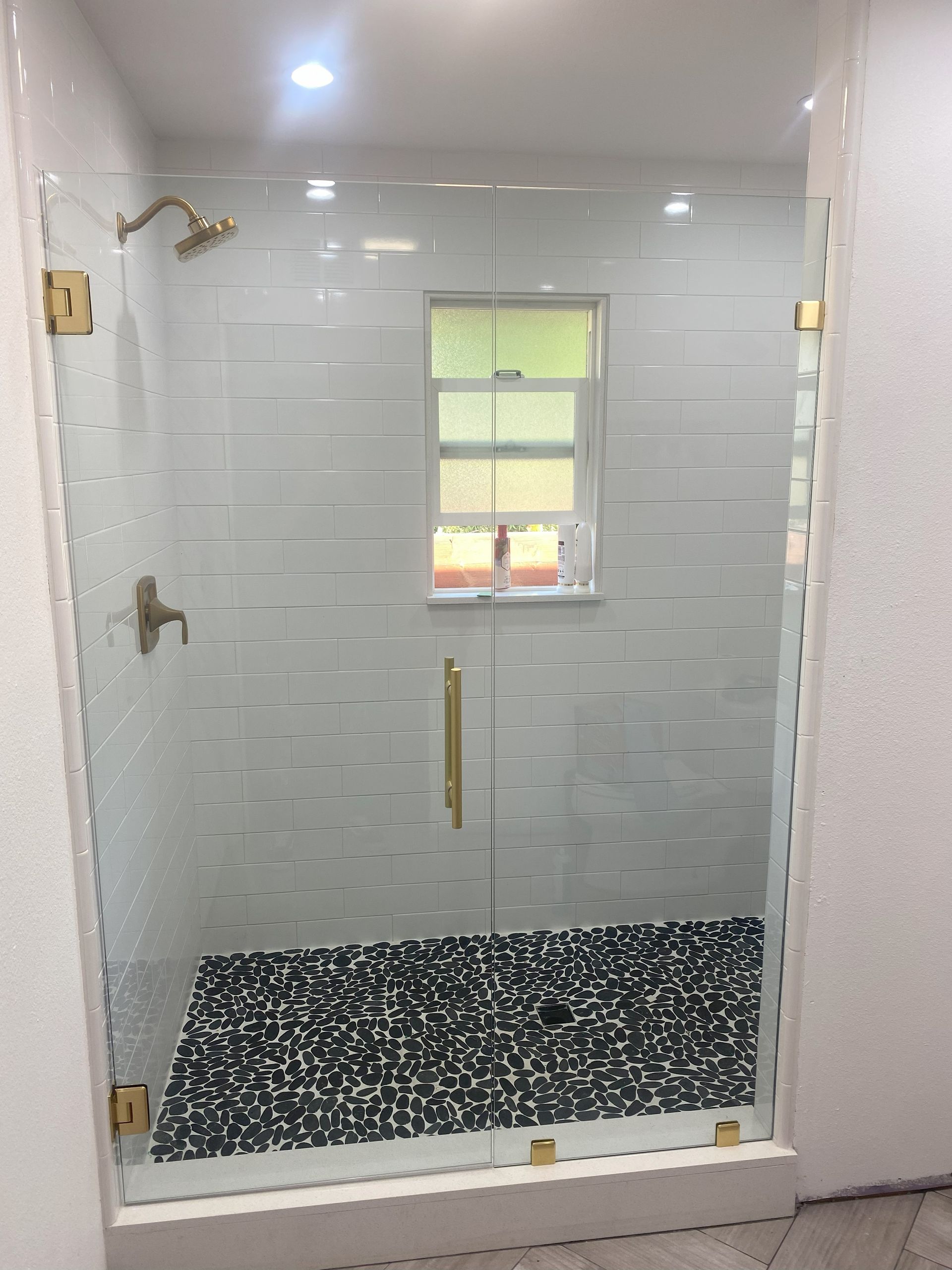 Luxury frameless shower door installation in residential home
