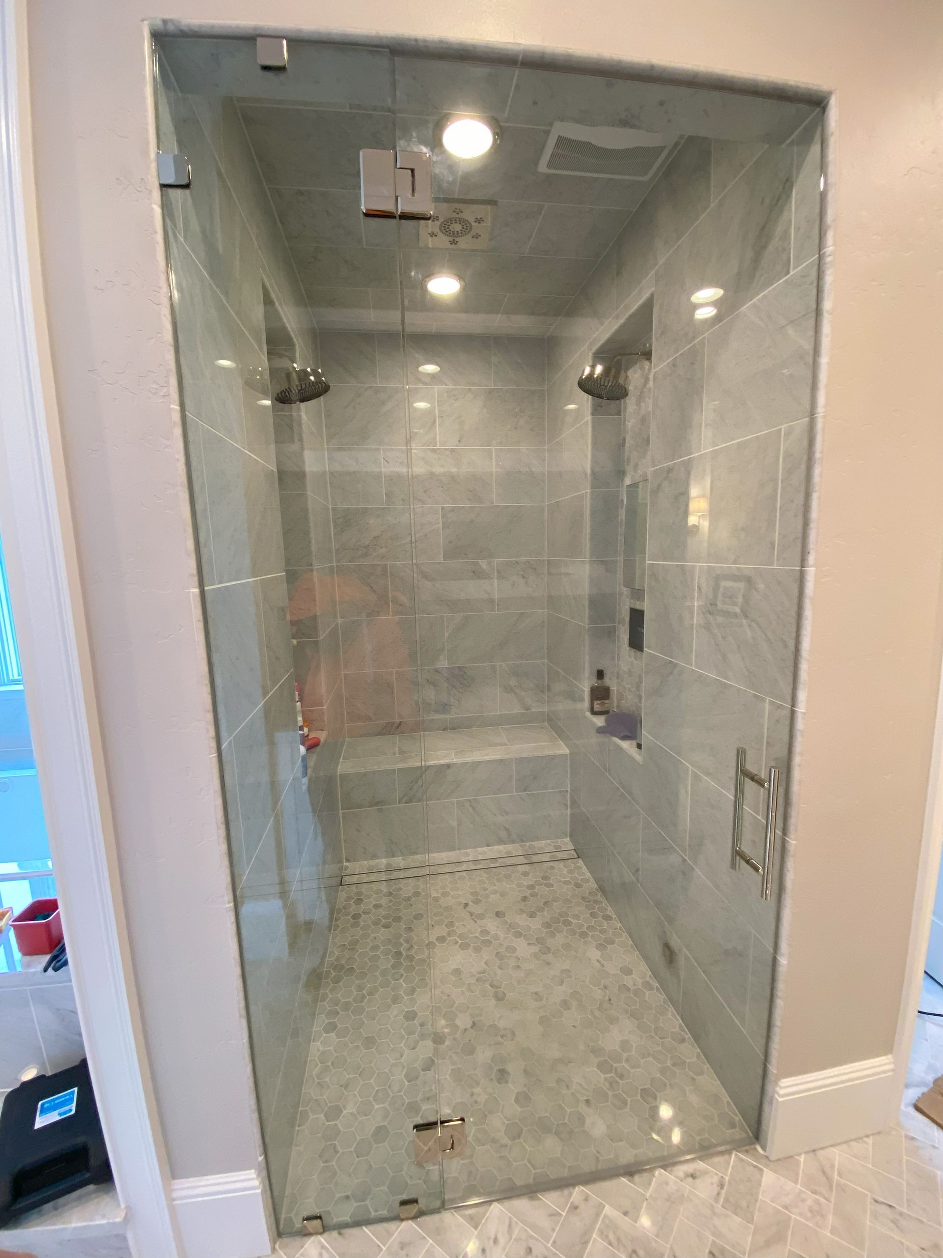 Frameless glass shower enclosure by Glassology featuring ultra-clear tempered glass and polished edges
