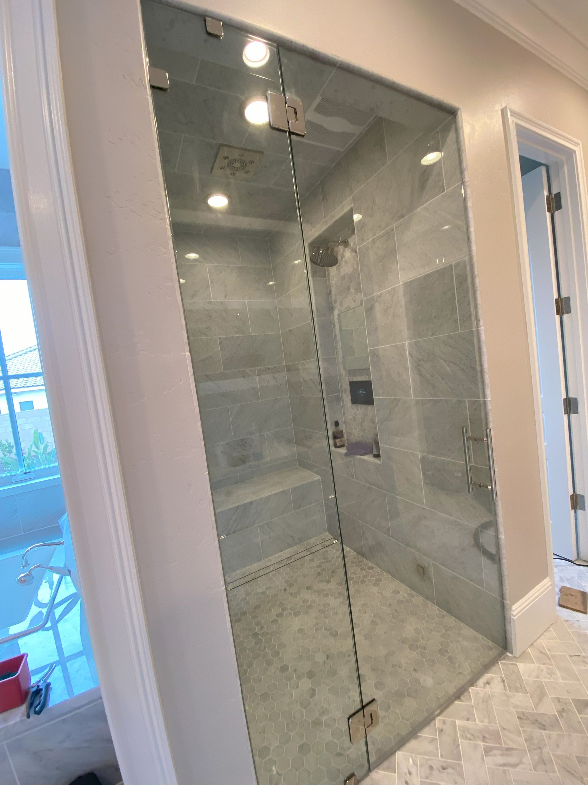 Modern bathroom with clear frameless glass shower panels