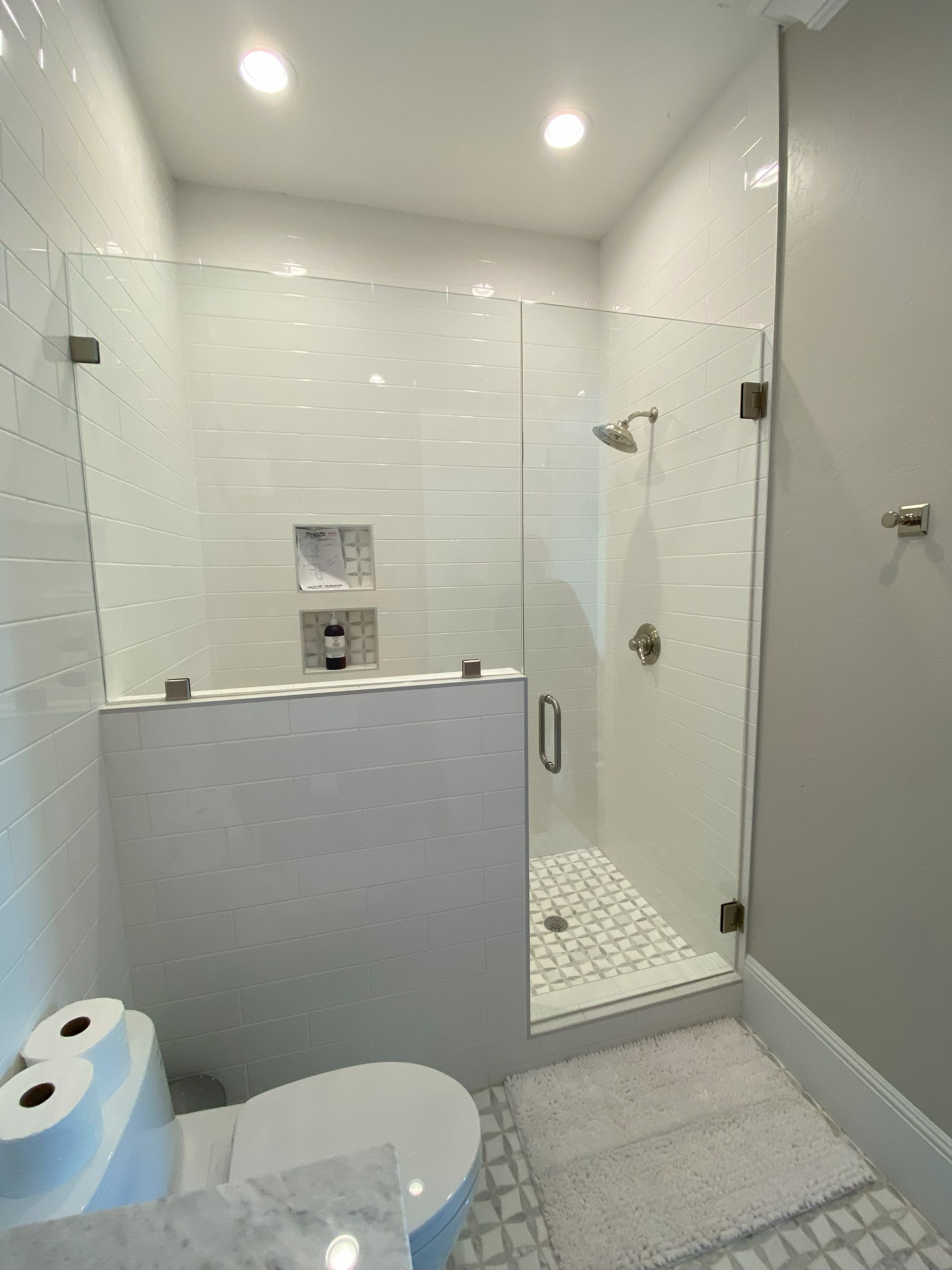 Frameless glass shower enclosure installed in San Antonio bathroom