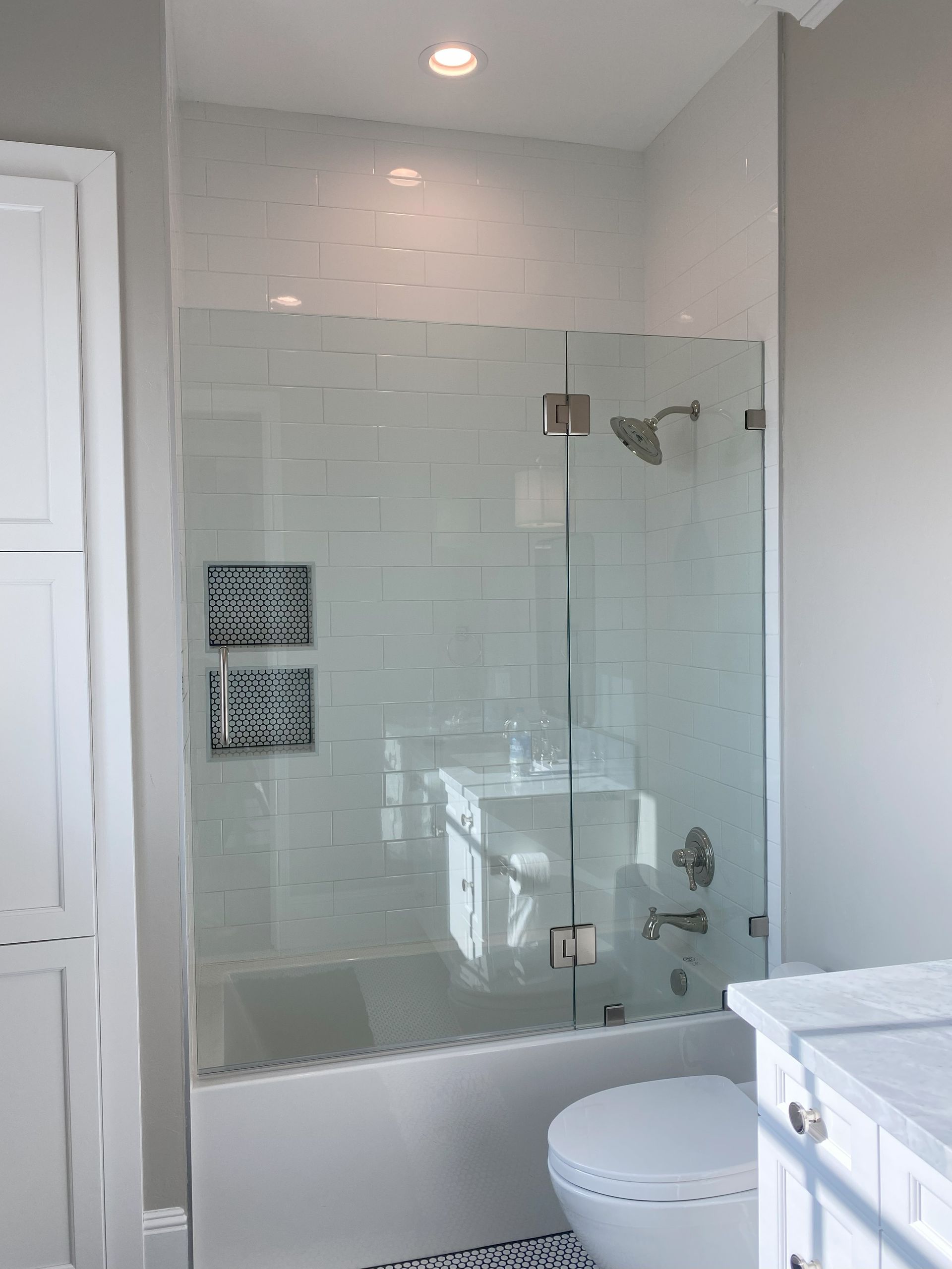 Luxury frameless glass shower by Glassology with crystal-clear panels and seamless joints
