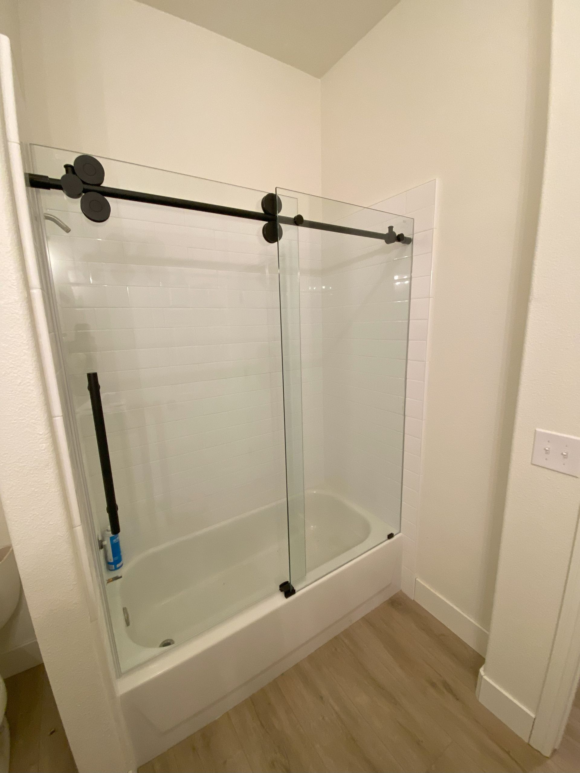 Frameless glass shower enclosure installed in San Antonio bathroom