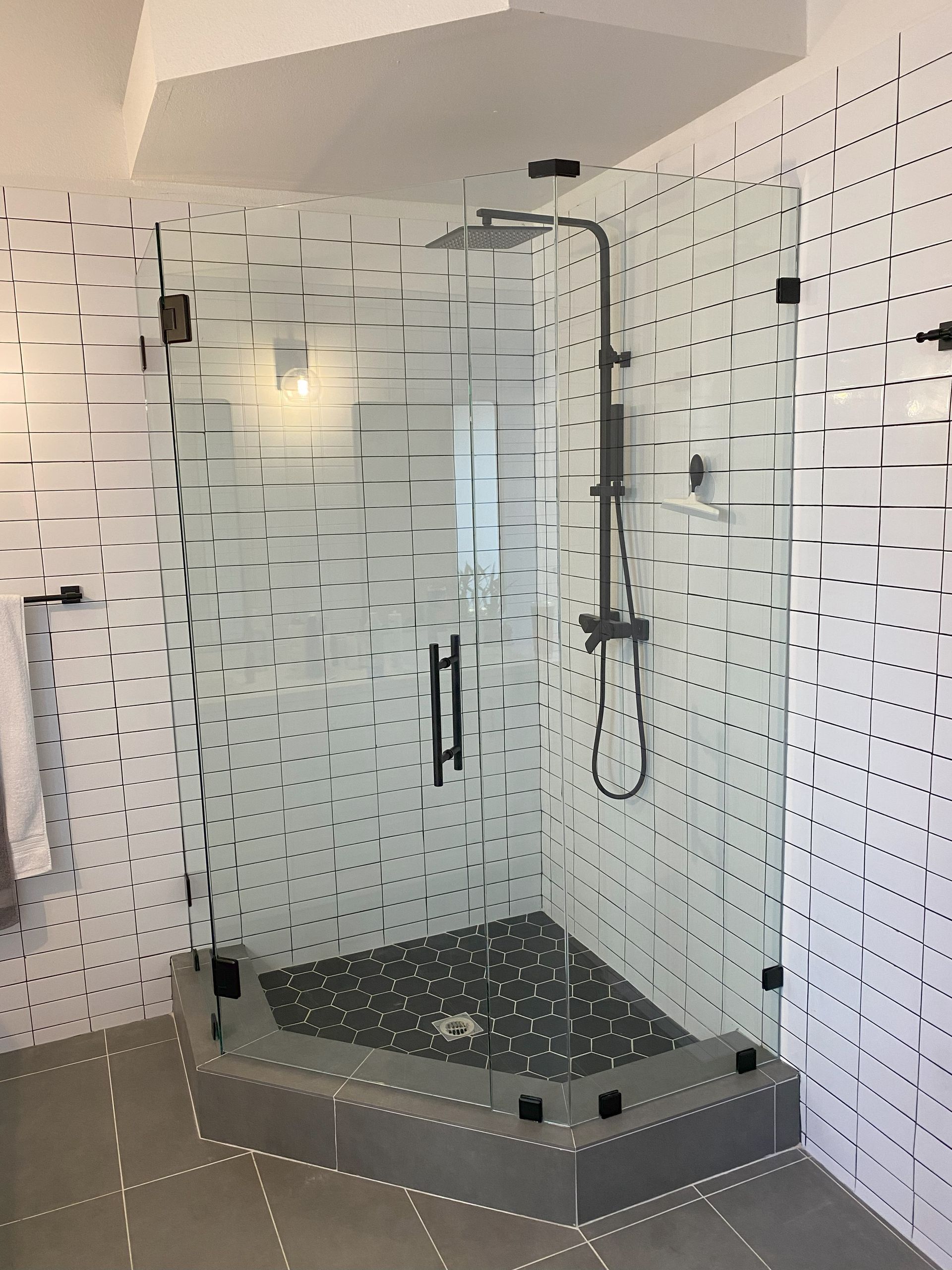 Custom glass enclosure by Glassology featuring minimal hardware and clean mounting points
