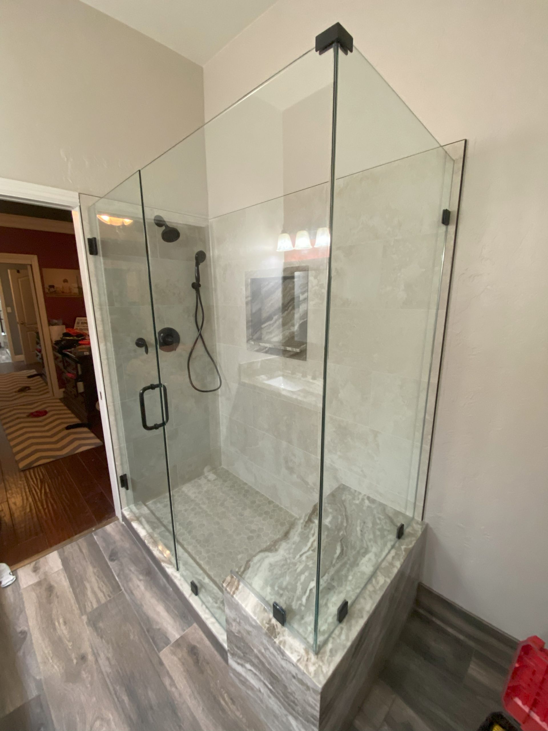 Frameless glass shower by Glassology with tight seam alignment and professional finishing
