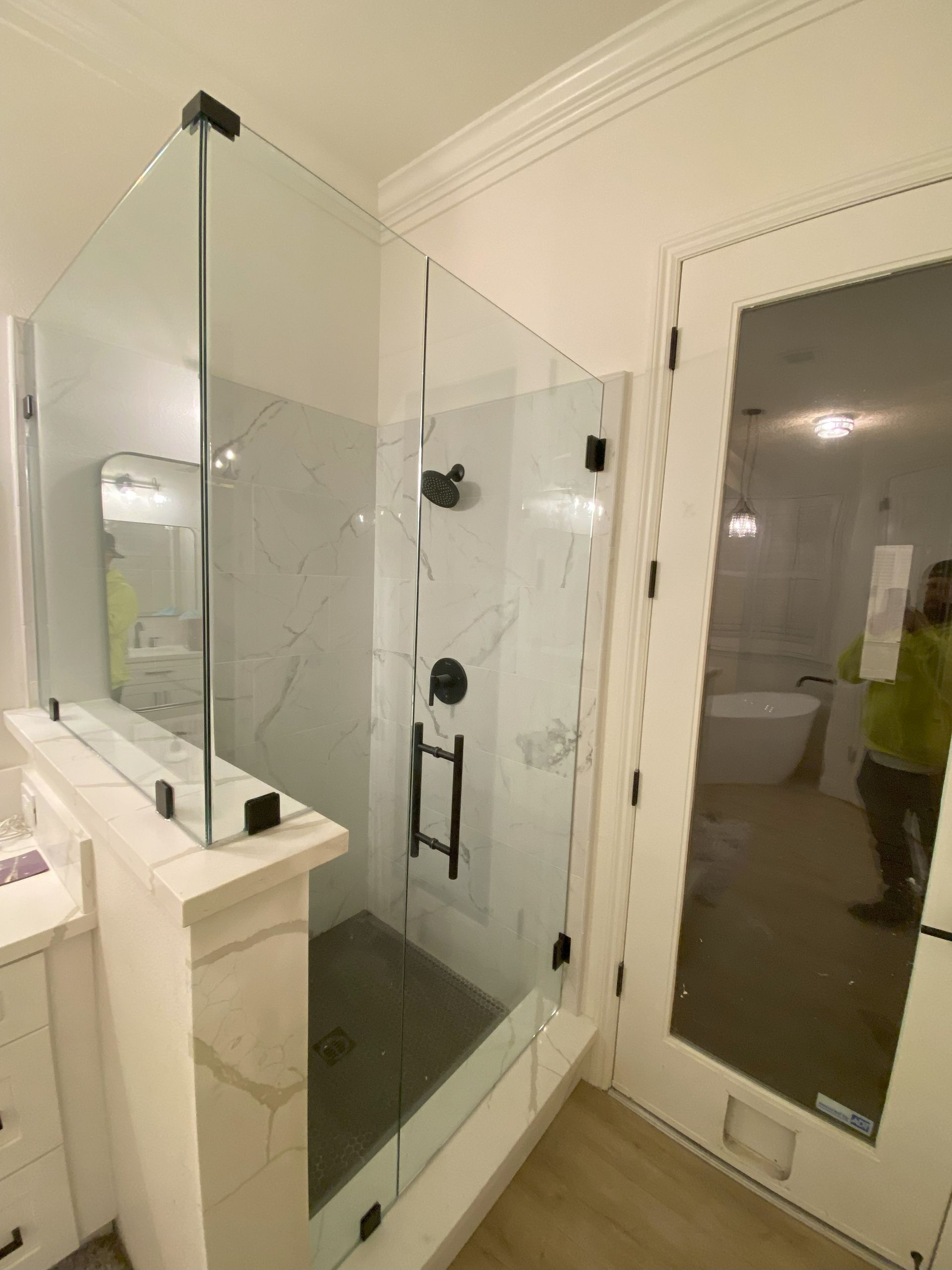 Custom glass shower installation by Glassology with precision-aligned panels and refined hardware
