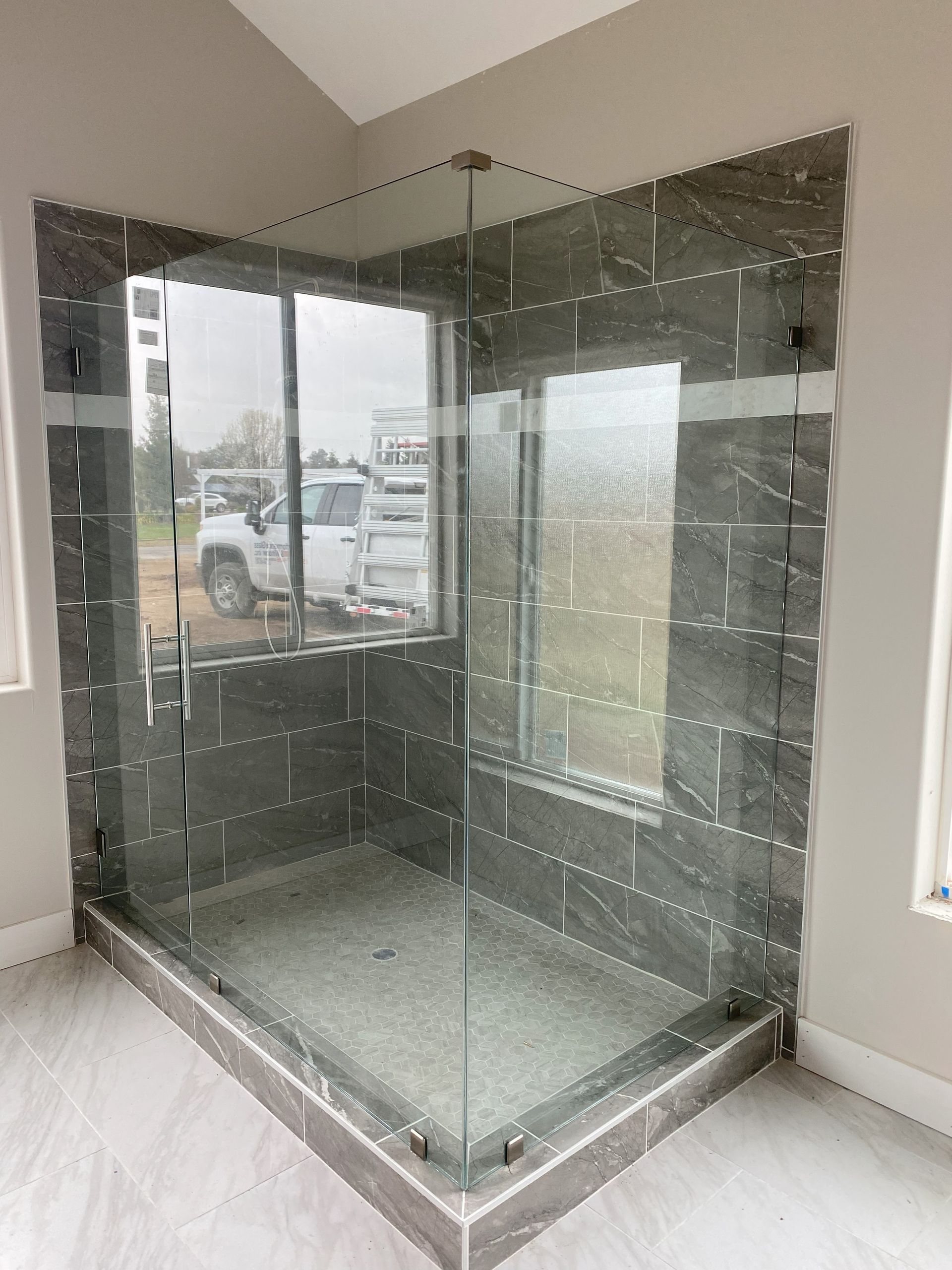 High-end glass shower system by Glassology with professional glazing and smooth edge finishing
