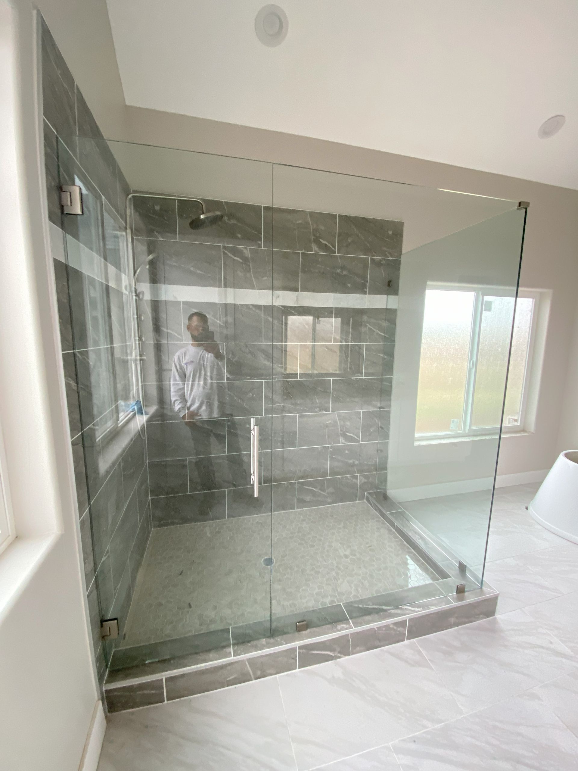 High-end glass shower system by Glassology with professional glazing and smooth edge finishing
