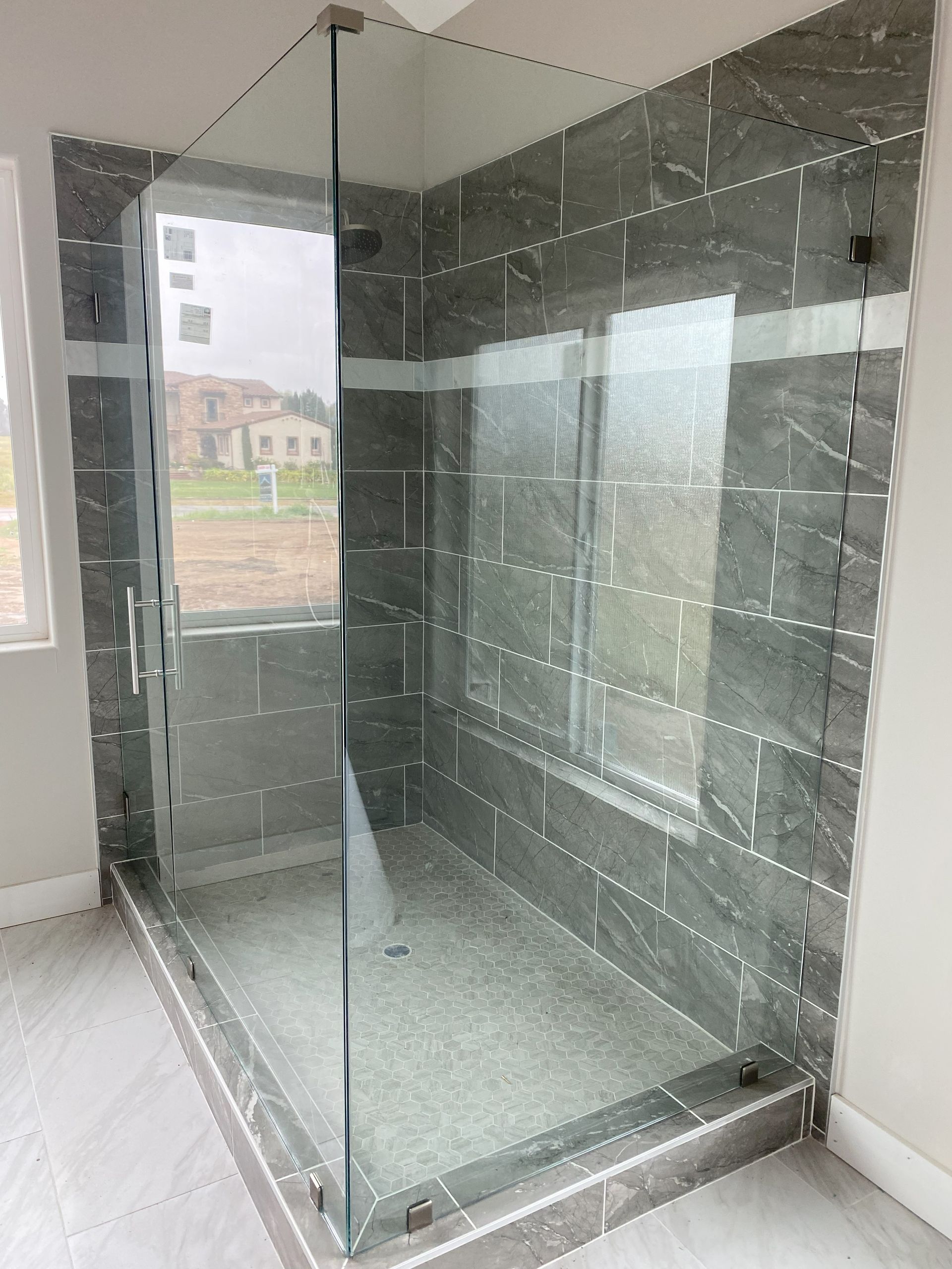 Custom glass shower by Glassology featuring clean glazing and enhanced clarity