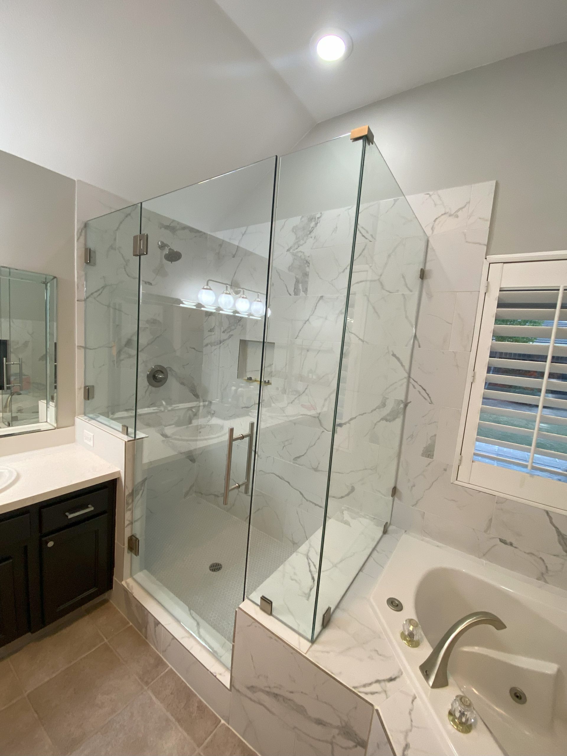 Custom glass enclosure by Glassology with expertly sealed seams and flush transitions
