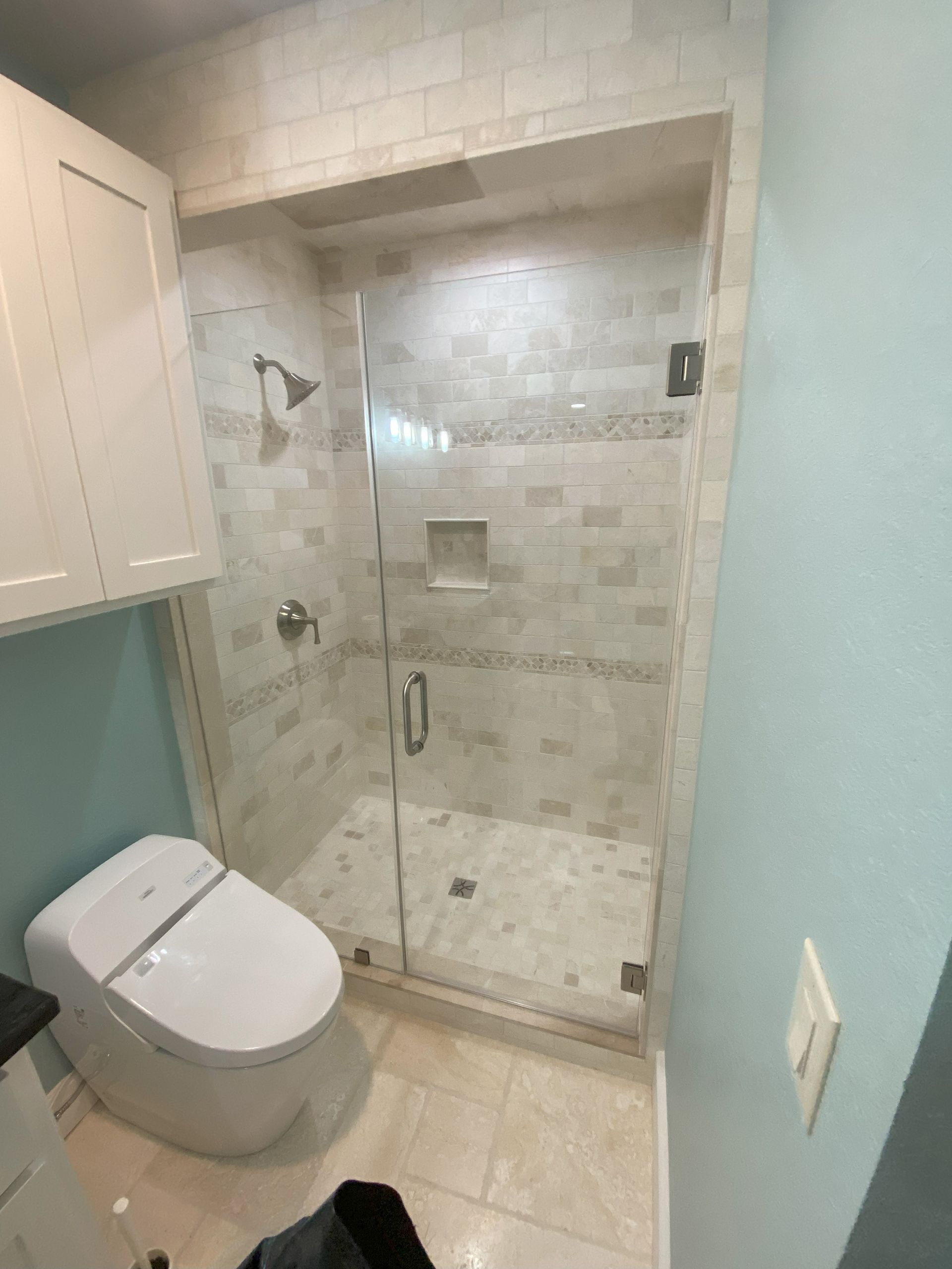 Frameless glass shower enclosure installed in San Antonio bathroom