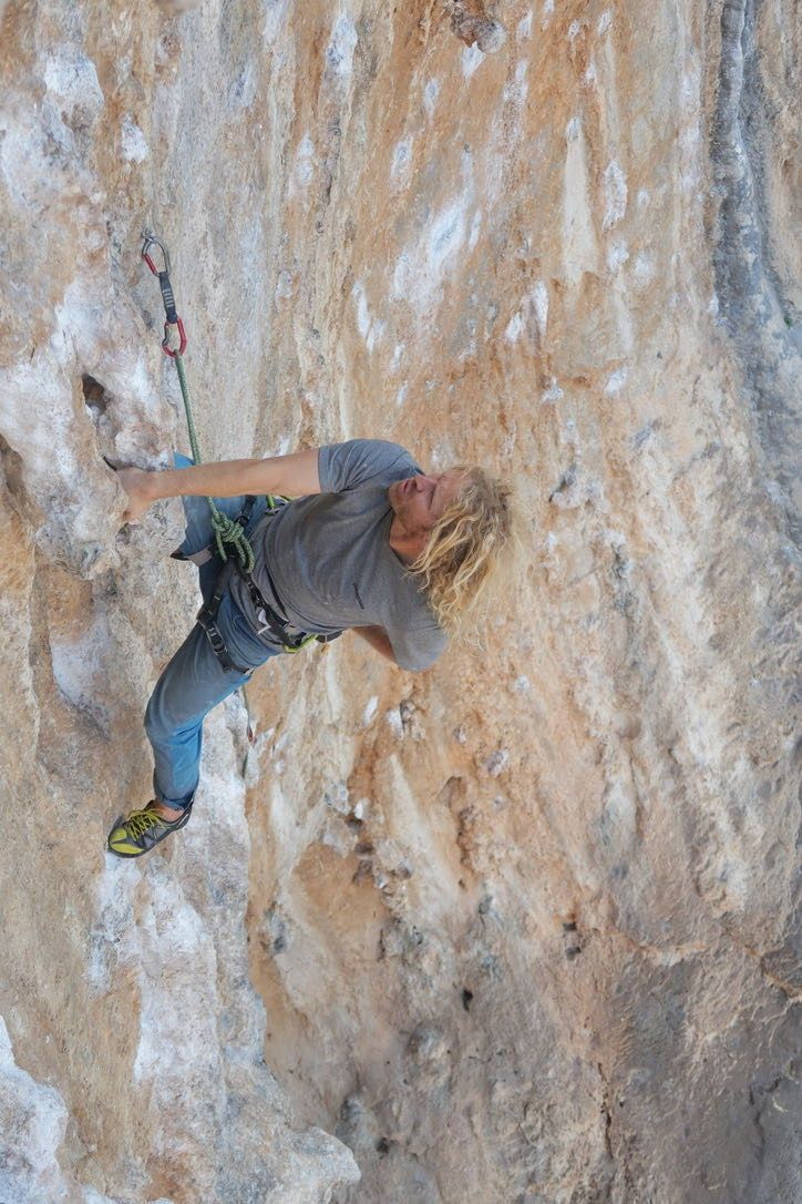 Climber taking a rest looking at the rest of the route