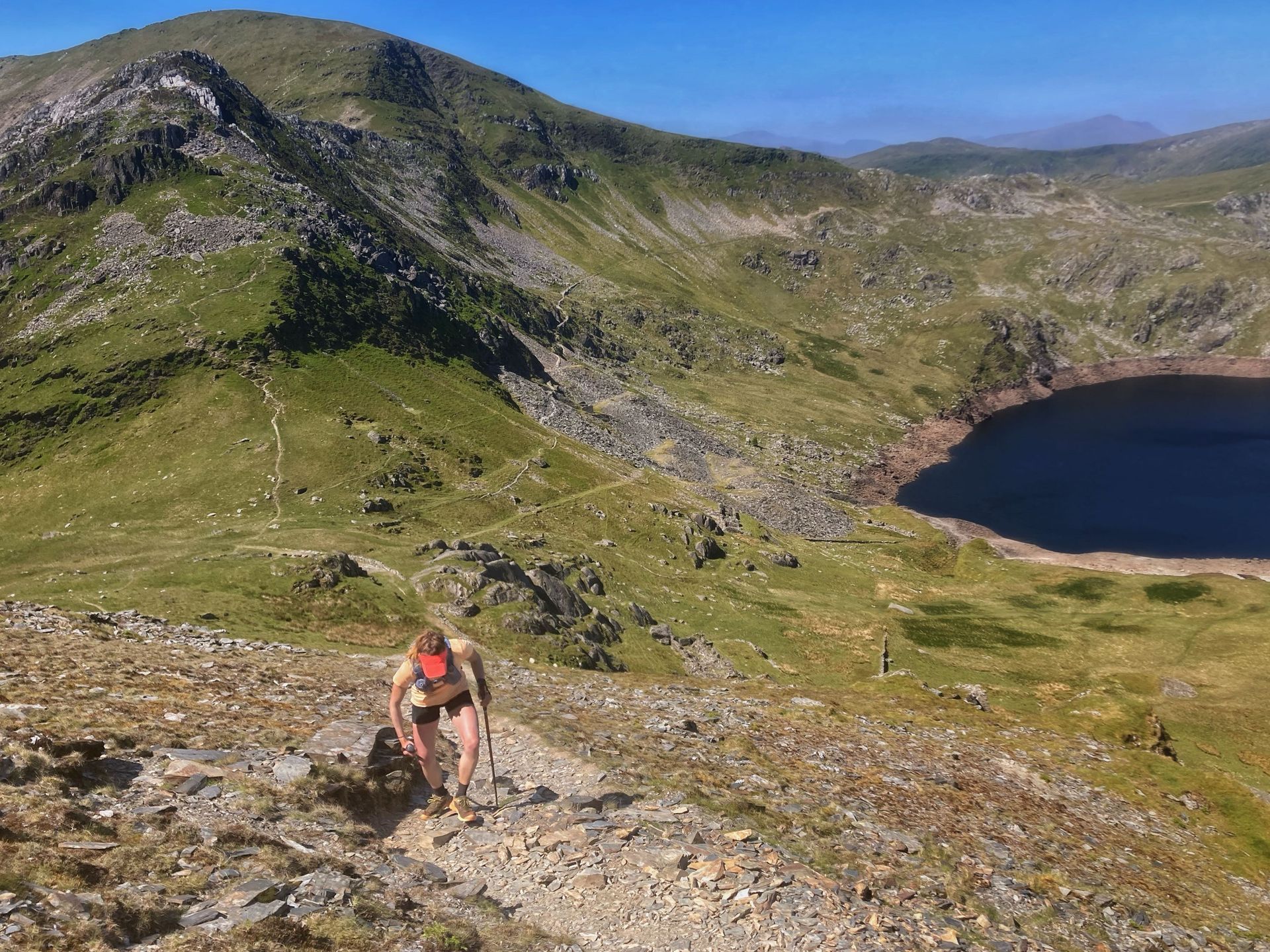 Runner using poles in the mountains