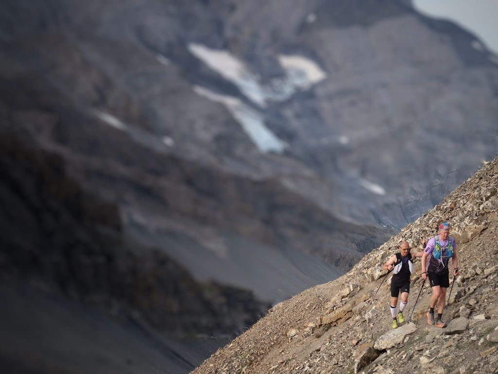 Runners traversing along a mountain