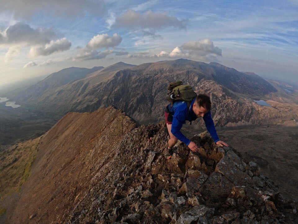 Climber on a knife edge ridge