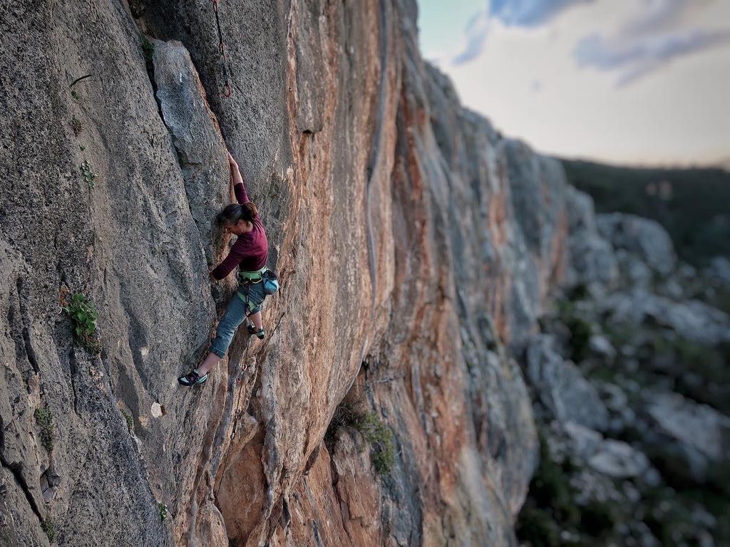 Female climbing orange rock