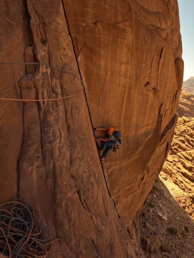 Orange rock with splitter crack being climbed