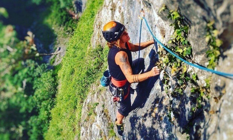 Female Climber with blue rope climbing