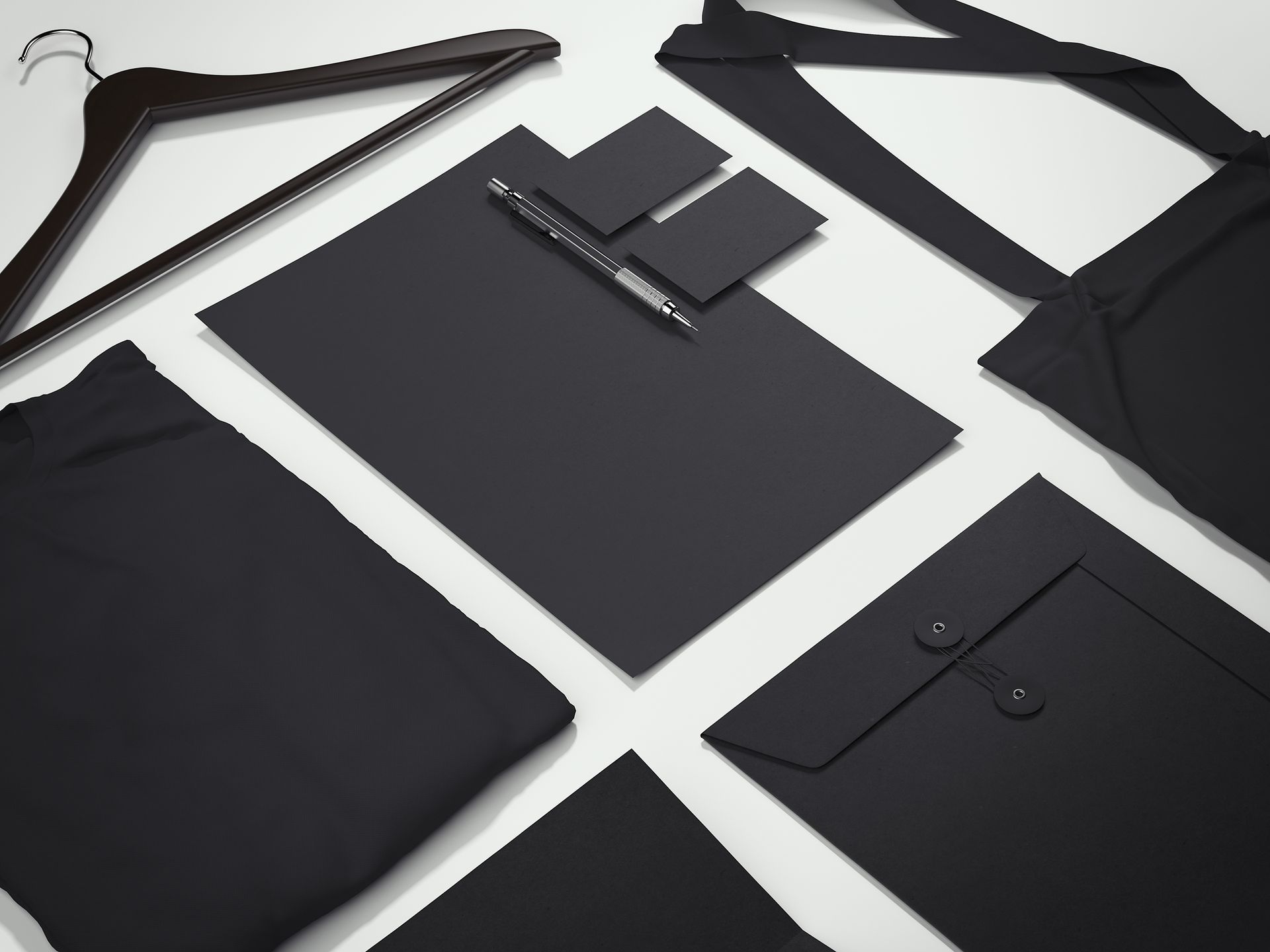 Black fabric tote bag filled with branded pens laid out on a table, with small items nearby. Black fabric tote bag filled with branded pens laid out on a table, with small items nearby.