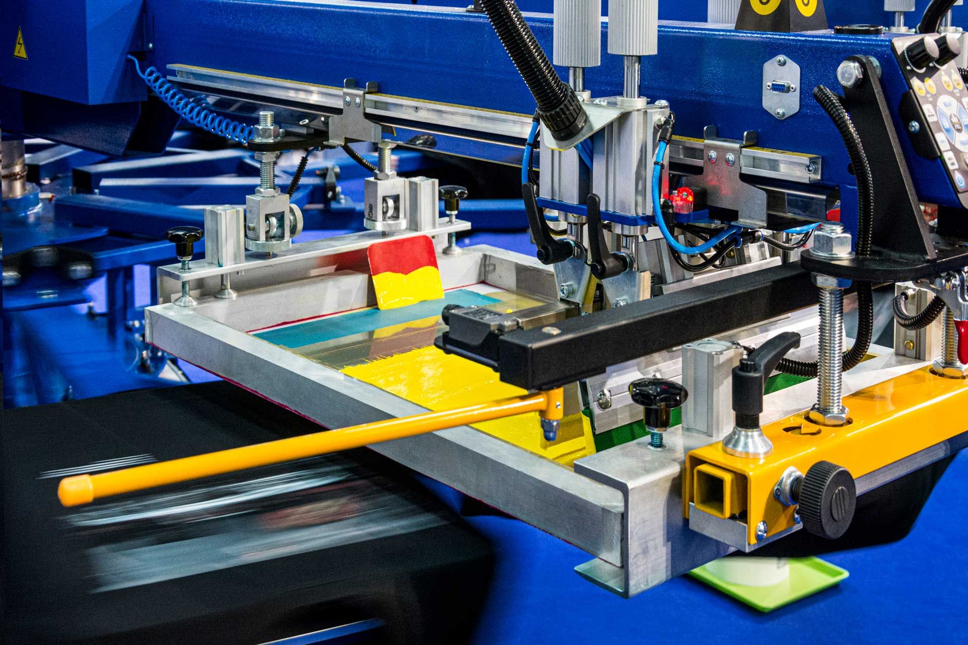 Automated screen printing machine producing colorful custom promotional products efficiently.