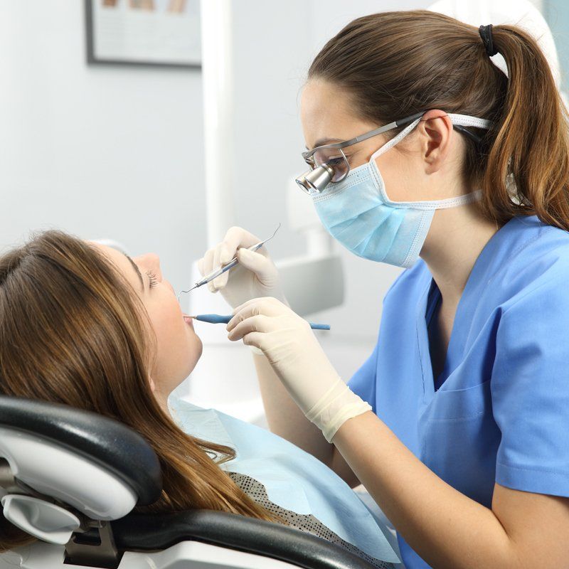 Dentist Examining a Patient Teeth — Bunbury WA — FADC Dental Group Dentist Examining a Patient Teeth — Bunbury WA — FADC Dental Group
