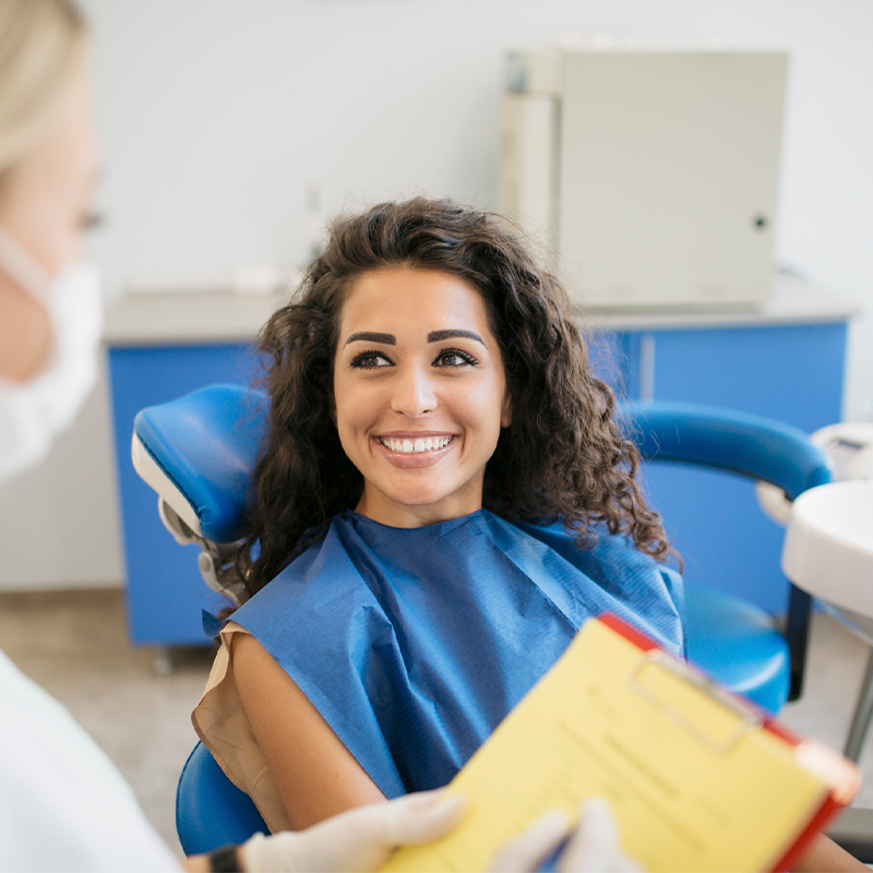 Attractive Young Caucasian Woman Talking to Her Dentist — Bunbury WA — FADC Dental Group Attractive Young Caucasian Woman Talking to Her Dentist — Bunbury WA — FADC Dental Group