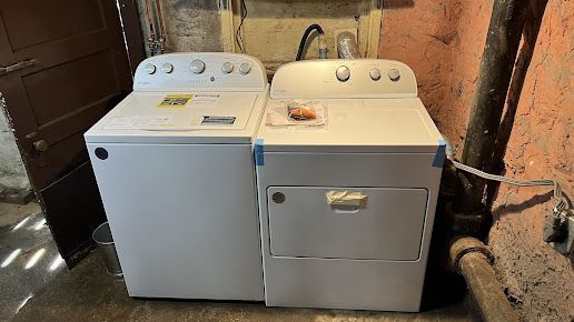 A washer and dryer are sitting next to each other in a room.