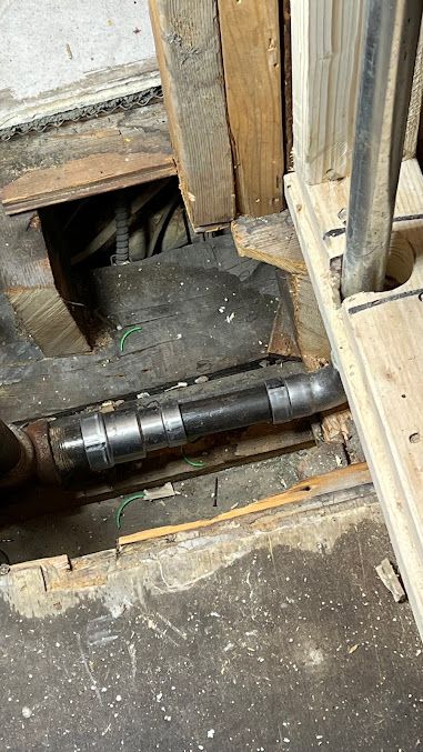 A pipe is coming out of a hole in the floor.