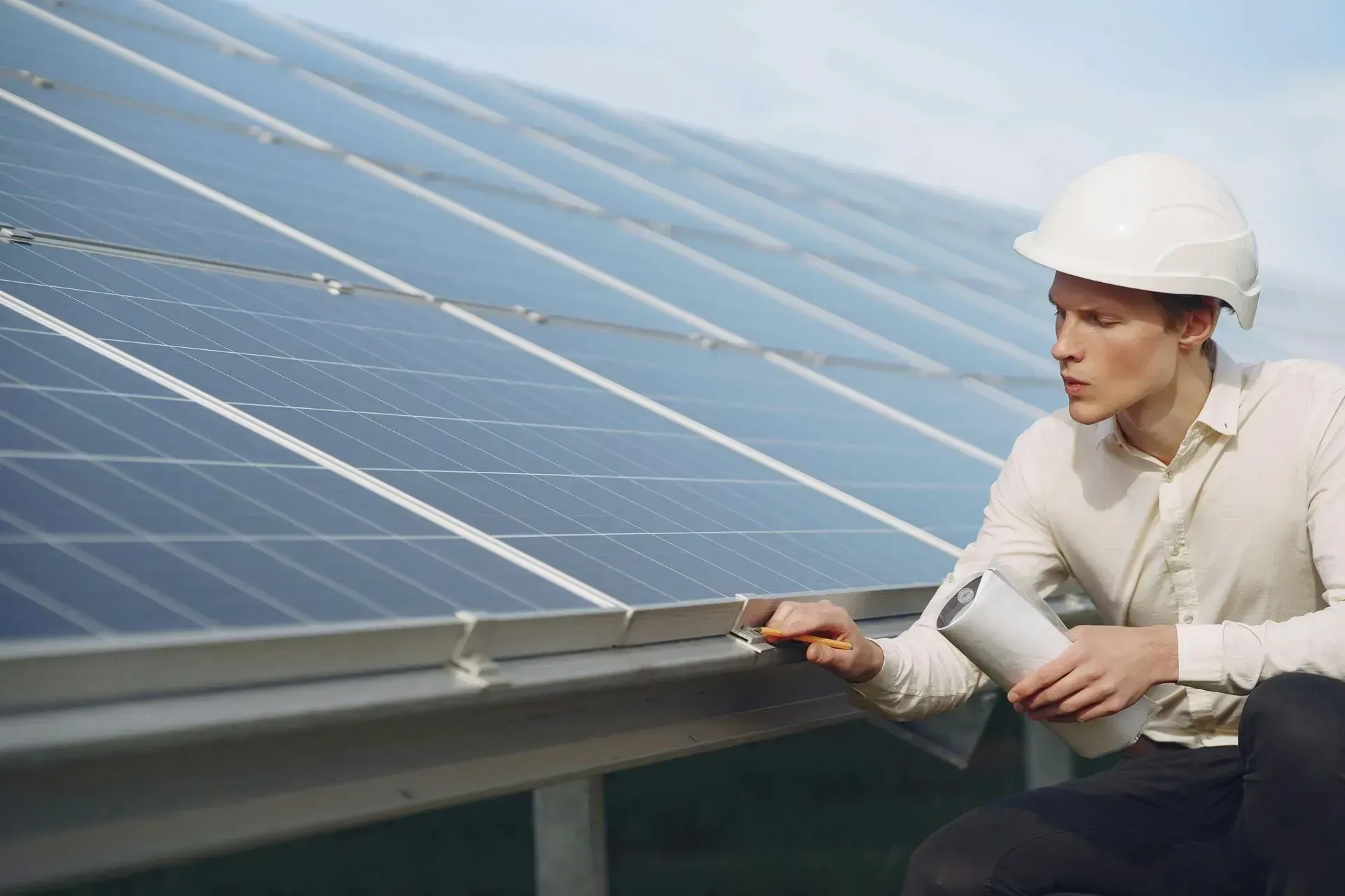 Technician inspecting rooftop solar panels during maintenance