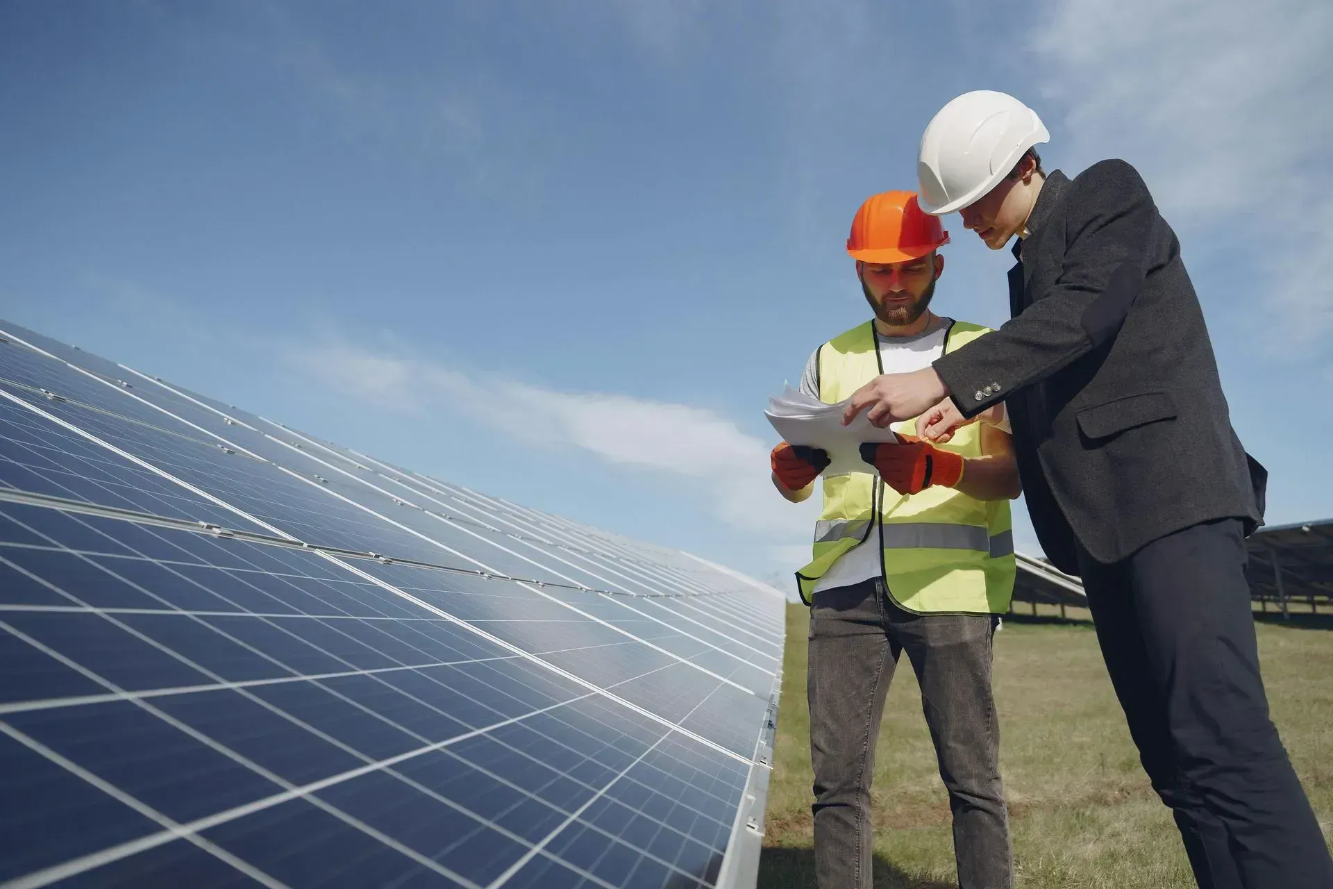 Solar installers reviewing system layout during maintenance